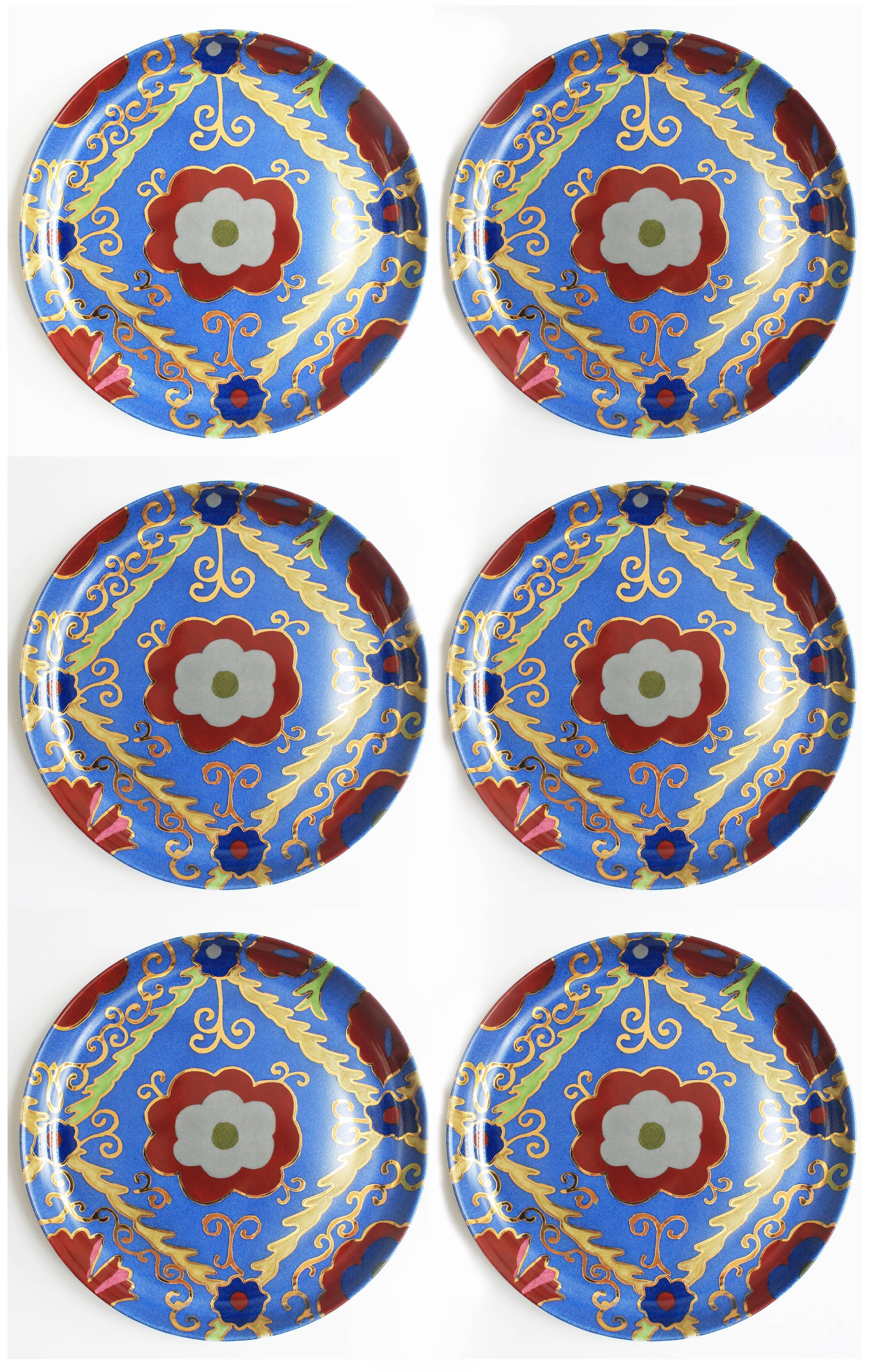 Set of hand-painted dinner and dessert plates with a beautiful Suzani motif by Arjumand's world by Idarica Gazzoni. The dinner plate is Egyptian red with gold, green and blue decoration. The dessert plate is indigo blue with red, green and gold