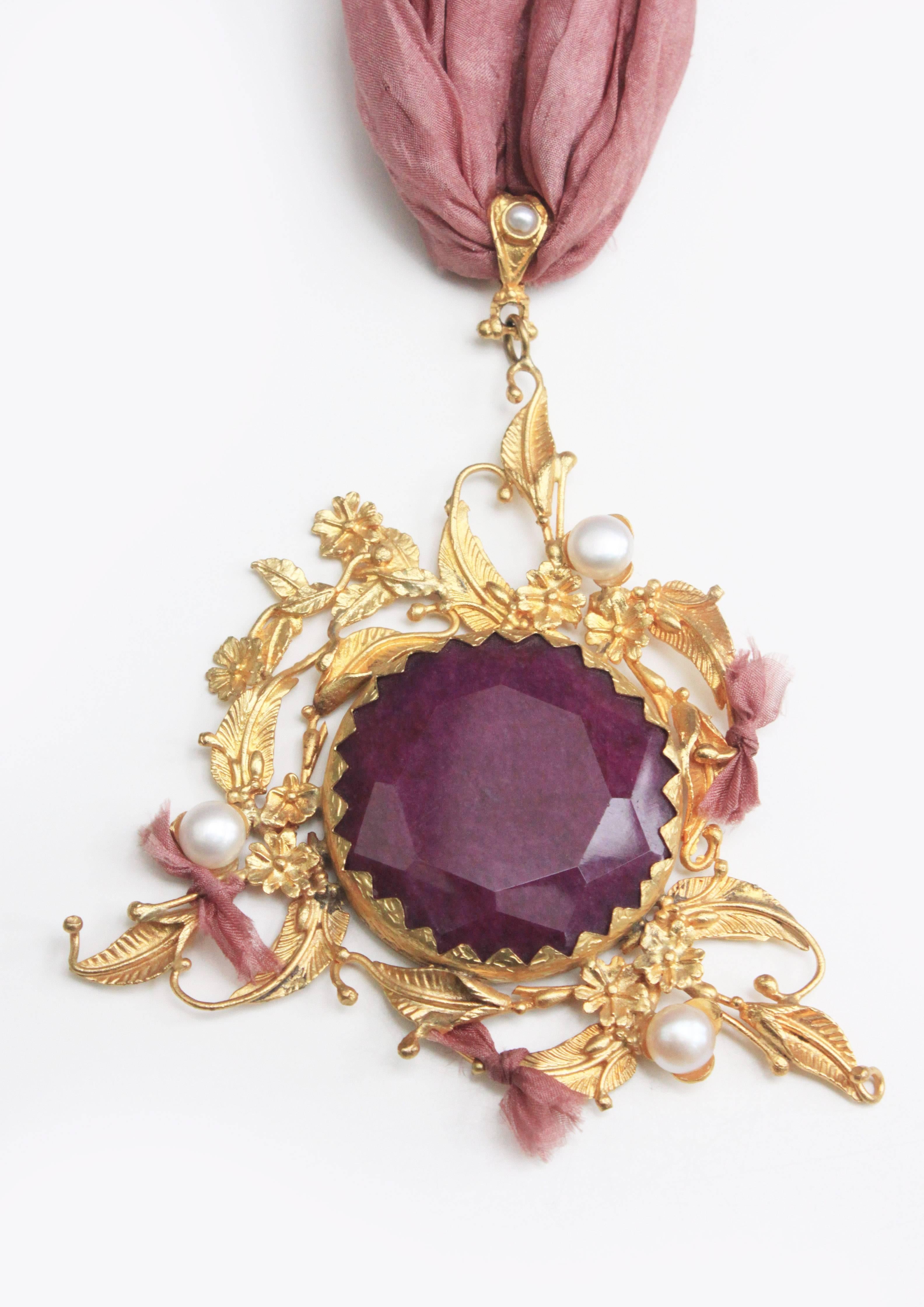 This unique handmade gold plated pendant was made in Afganistan, it comes with beautiful mixed precious stones and pearls on long pink silk necklace. 