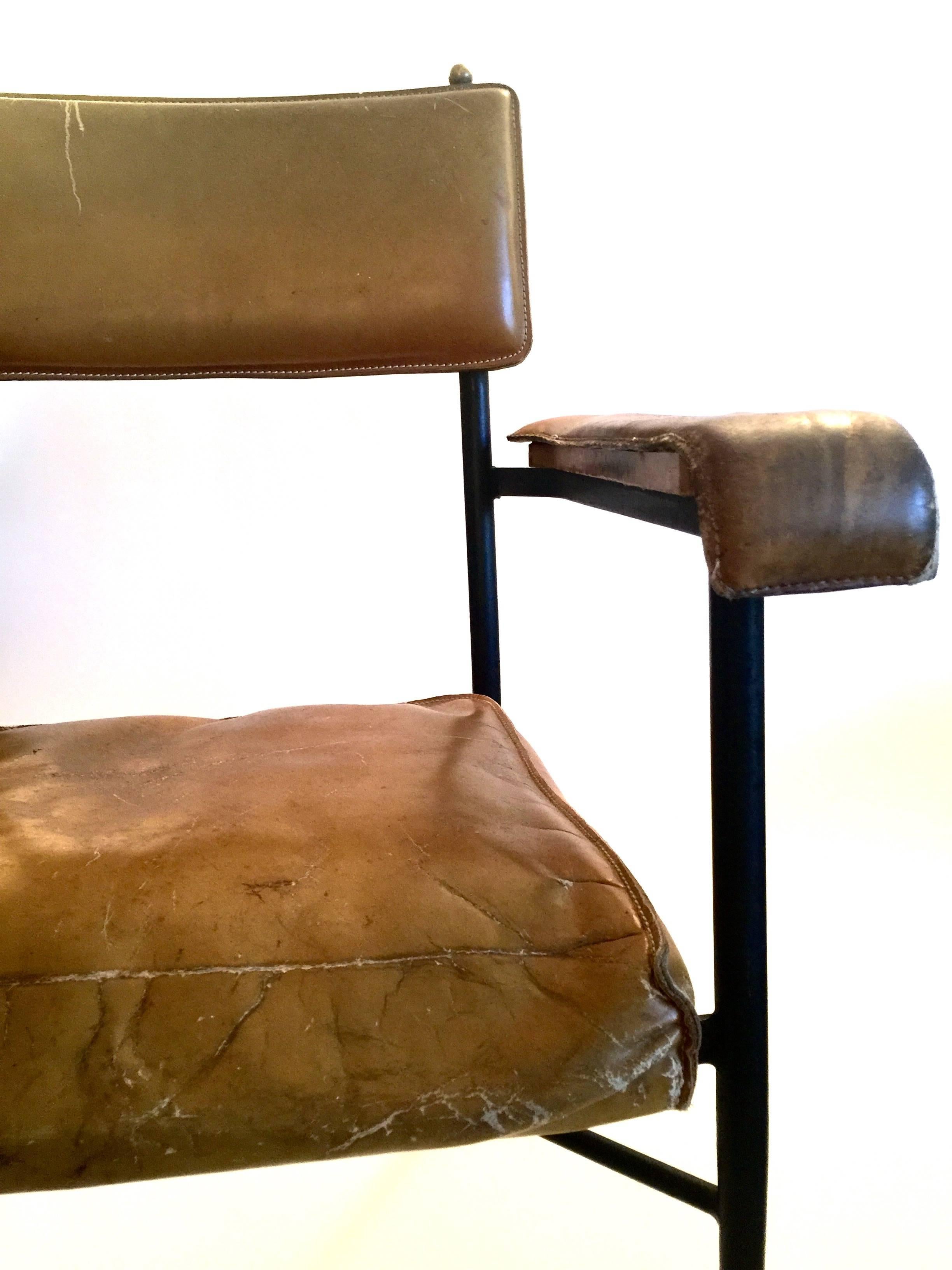 Pair of leather armchairs by Jacques Adnet.