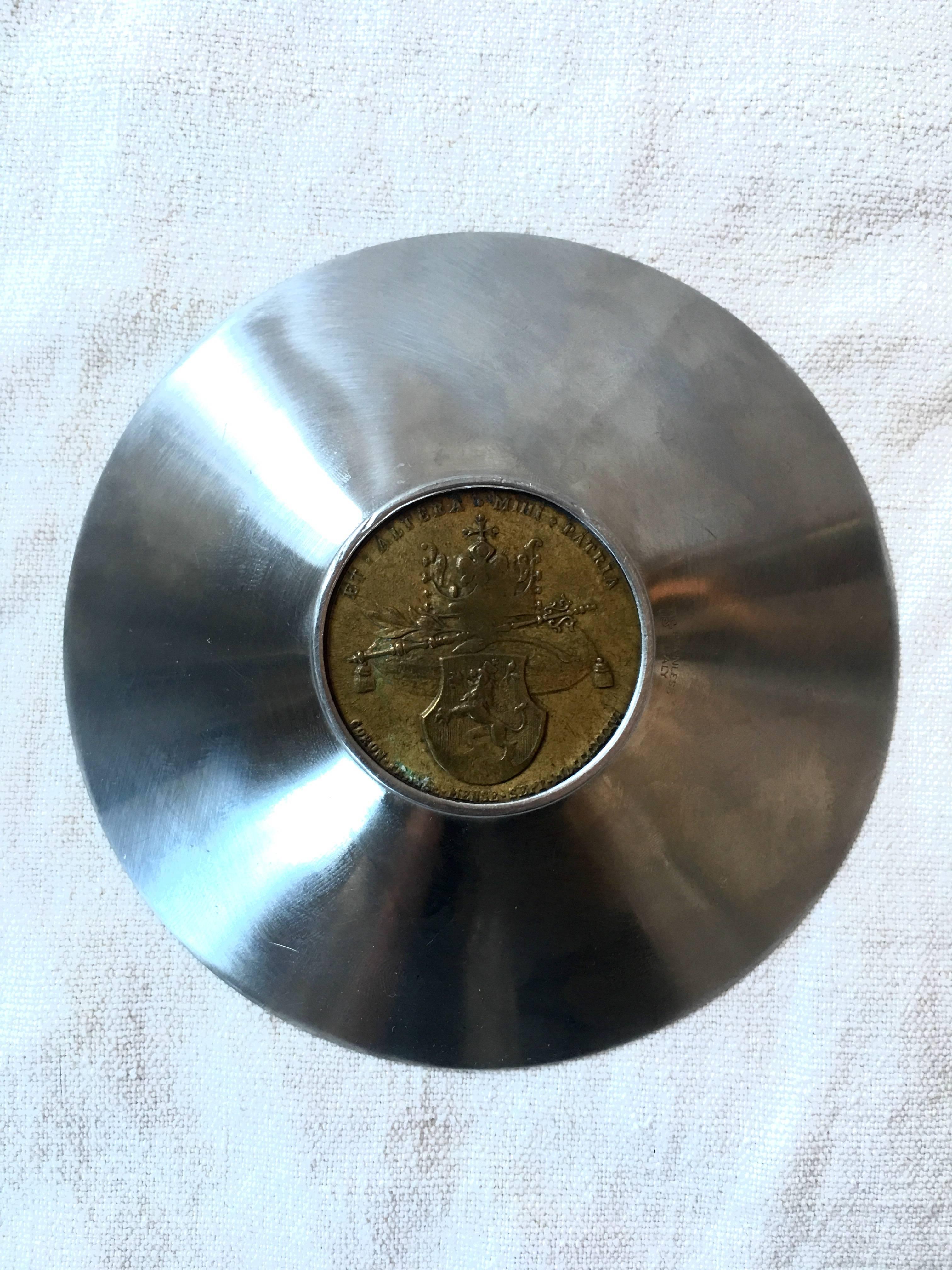Italian metal bowl made of stainless steel and a large vintage coin.