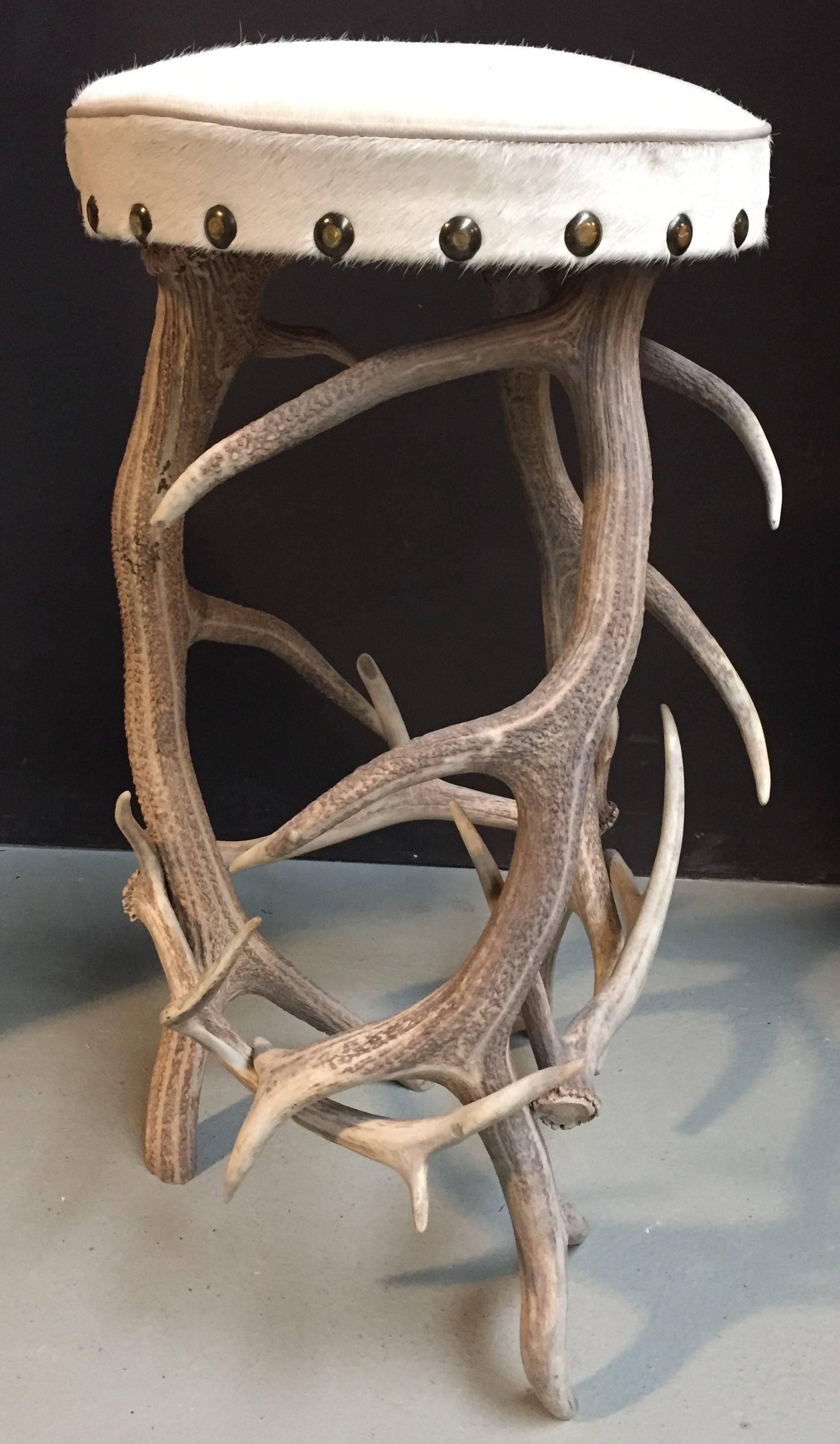 Bar stool made of red deer antlers, upholstered with Equadorian cow hide.