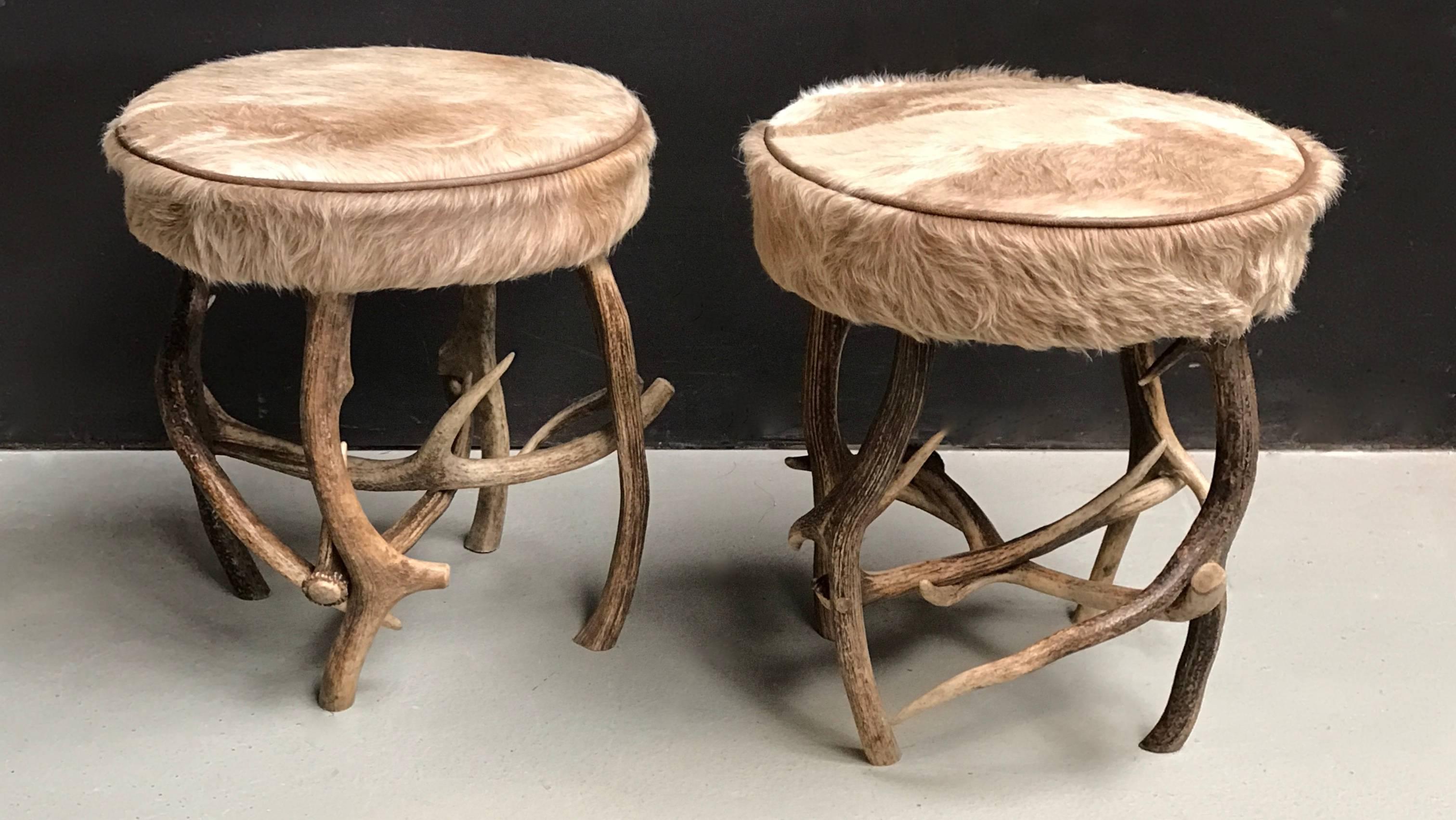Pair of antler stools made of red deer antlers.
Both stools are upholstered out of one A-grade South American cowhide to make the pair of stools a perfect match.