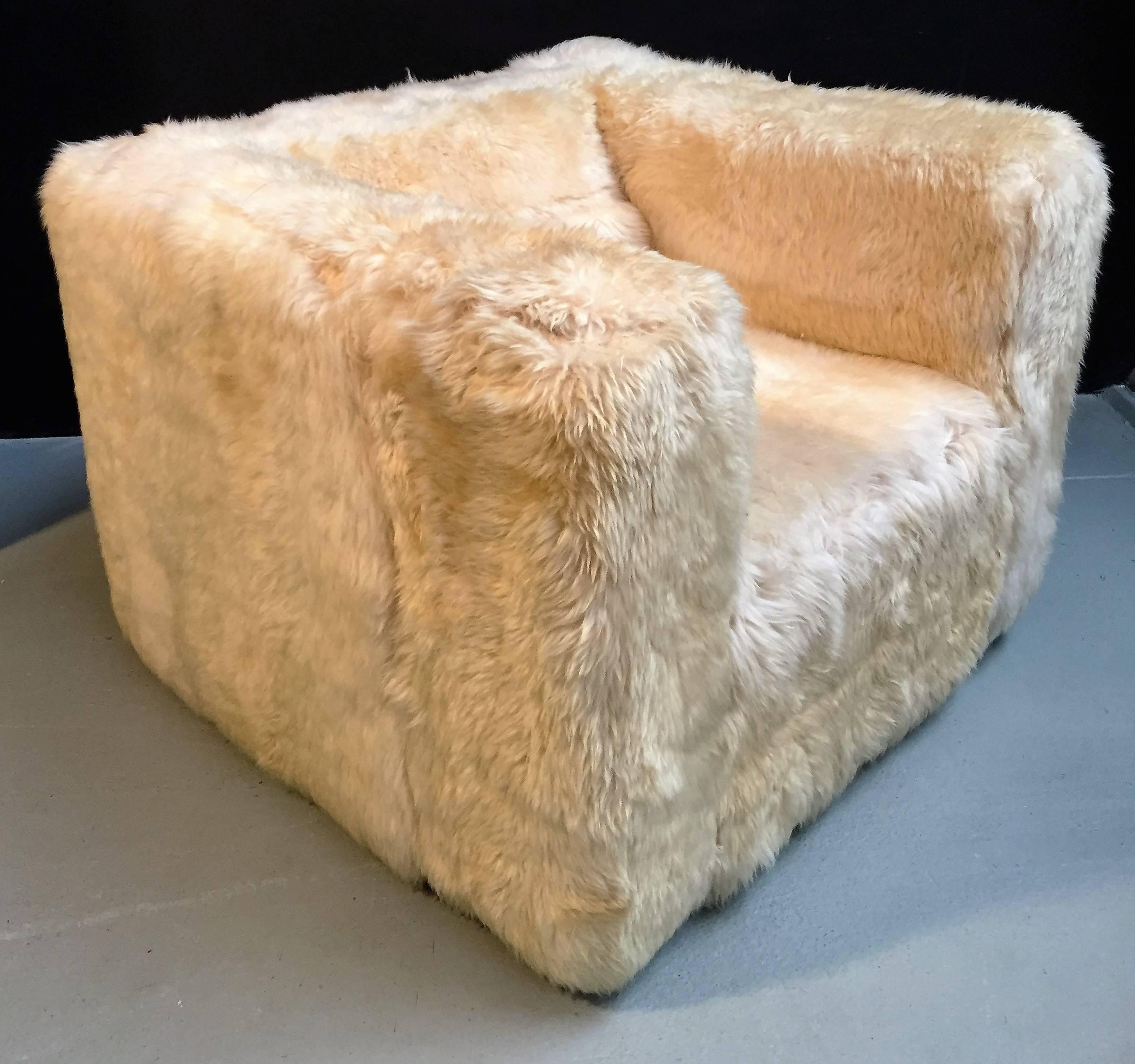 Comfortable cube chair upholstered with natural sheepskin.