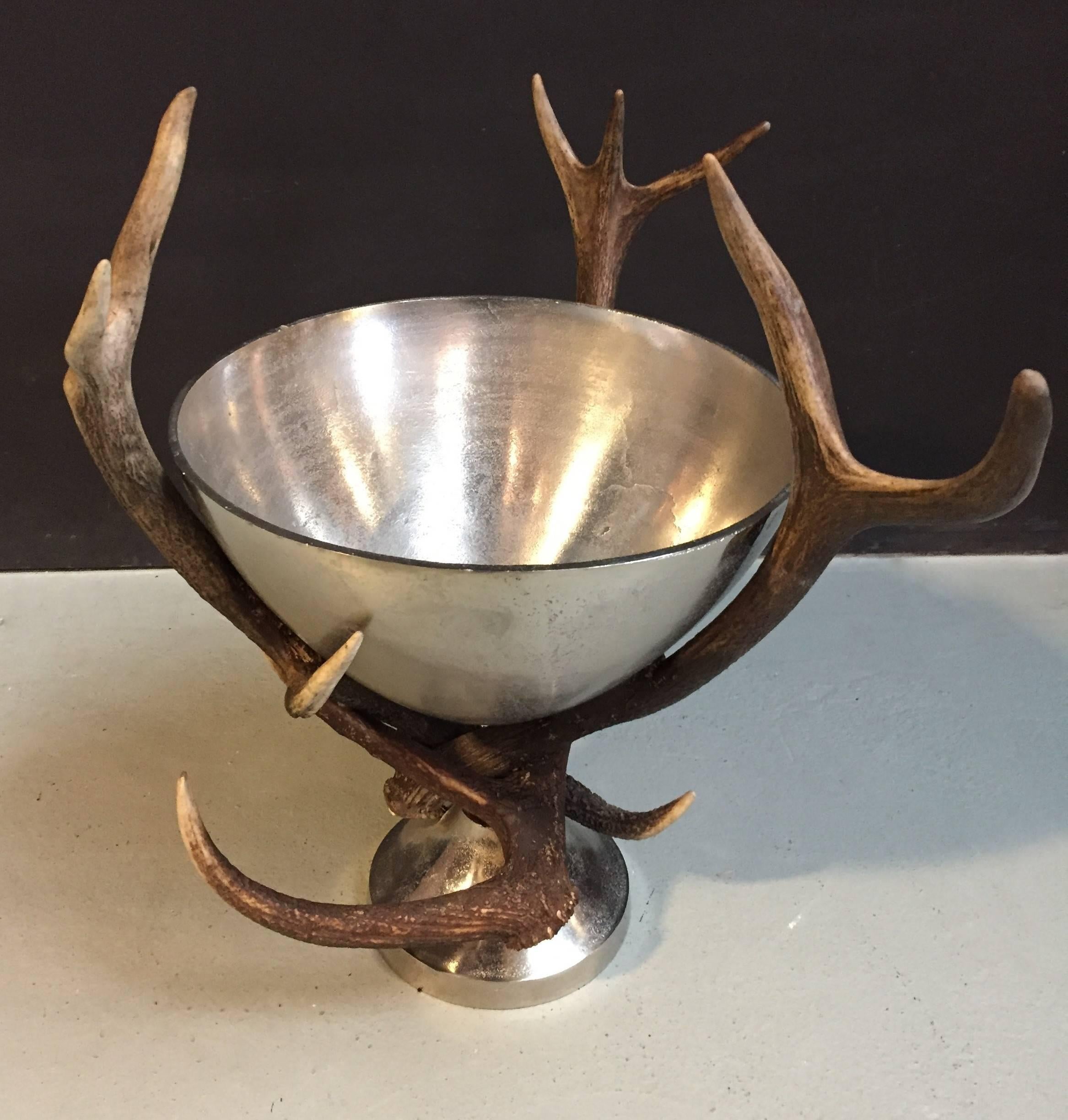 Champagne cooler decorated with red deer antlers.