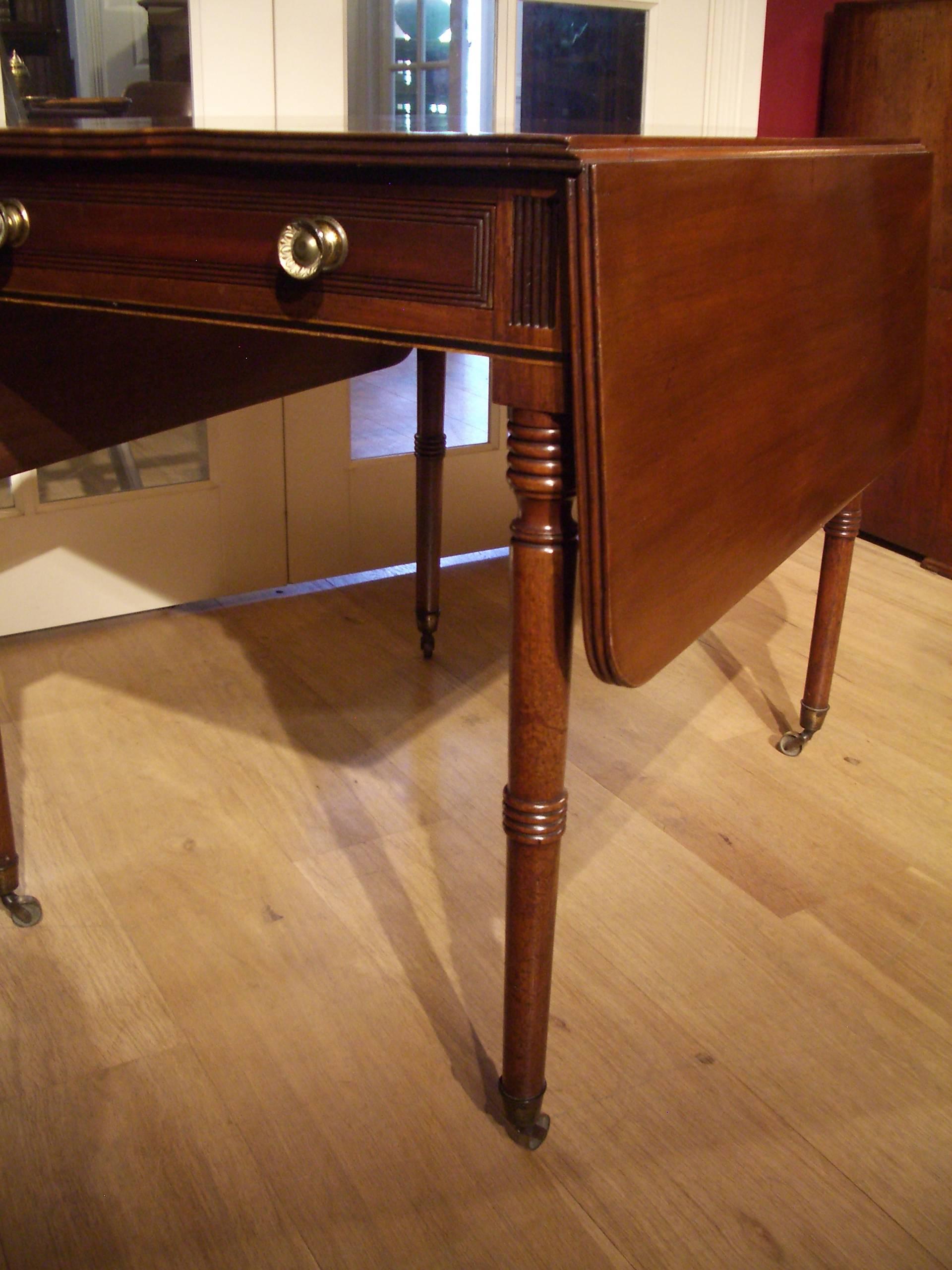 Beautiful completely original antique pembroke table with one drawer the table stands on brass wheels. Warm mahogany color.

Origin: England

Period: circa 1830

Size: W 31cm-60cm-31cm, D 83cm, H 73cm.

Pembroke table, table designed for