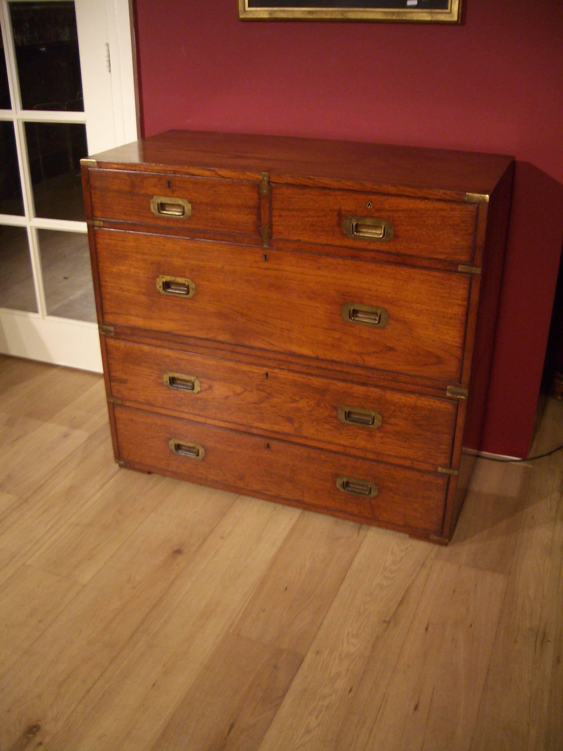 Impressive teak wooden Victorian Campaign chest of drawers. It consists of two parts and is in original condition. The chest of drawers is produced by the company Army and Navy C.L.S. (for more information, read at the end) the chest of drawers has
