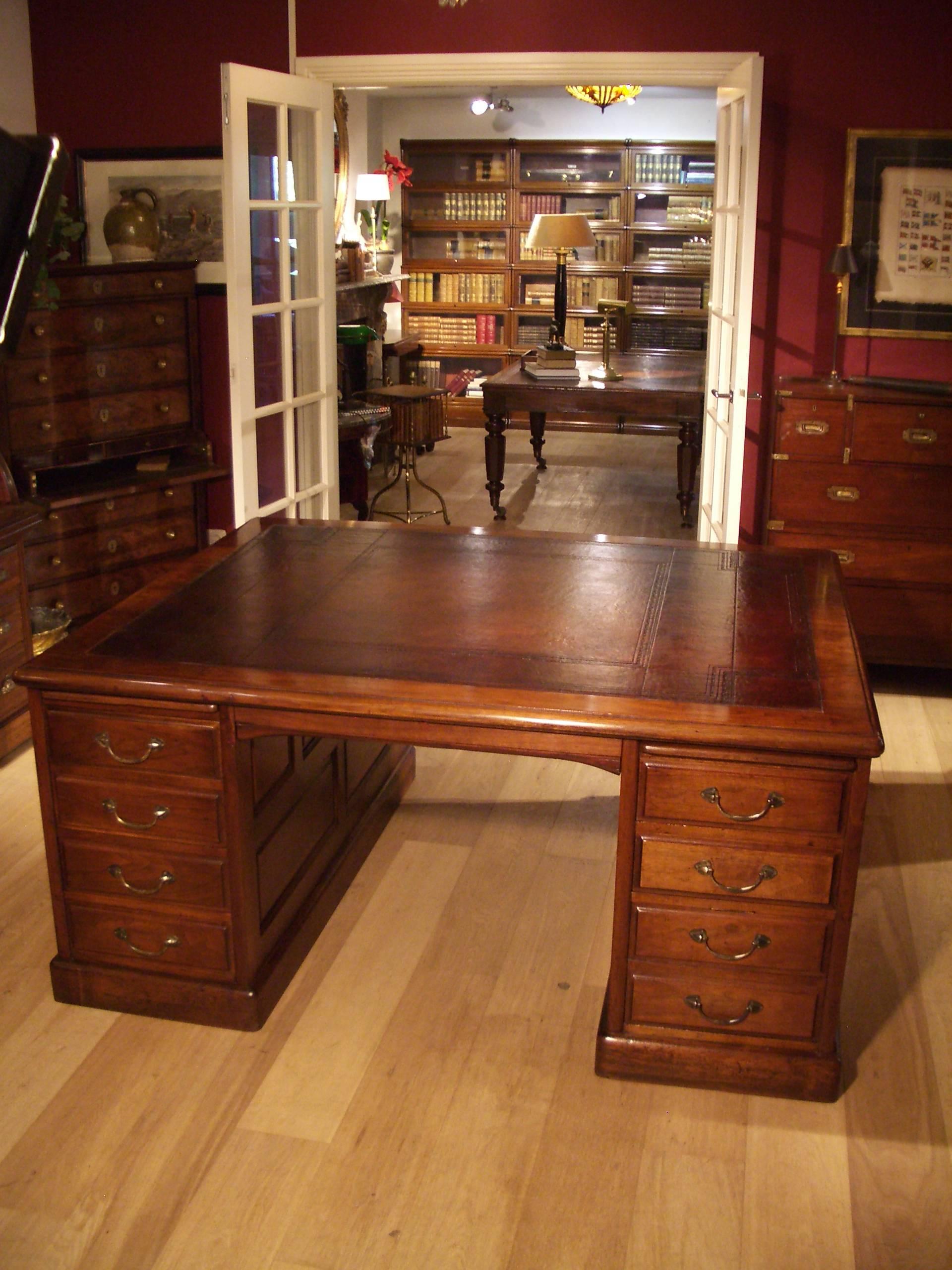 Beautiful large antique walnut desk. Completely in perfect condition. Desk has 18 drawers and four pull-out leaves. Beautifully framed. Hand-colored brown leather with blind tooling. Warm color. The depth of 135cm is special and makes it ideal for