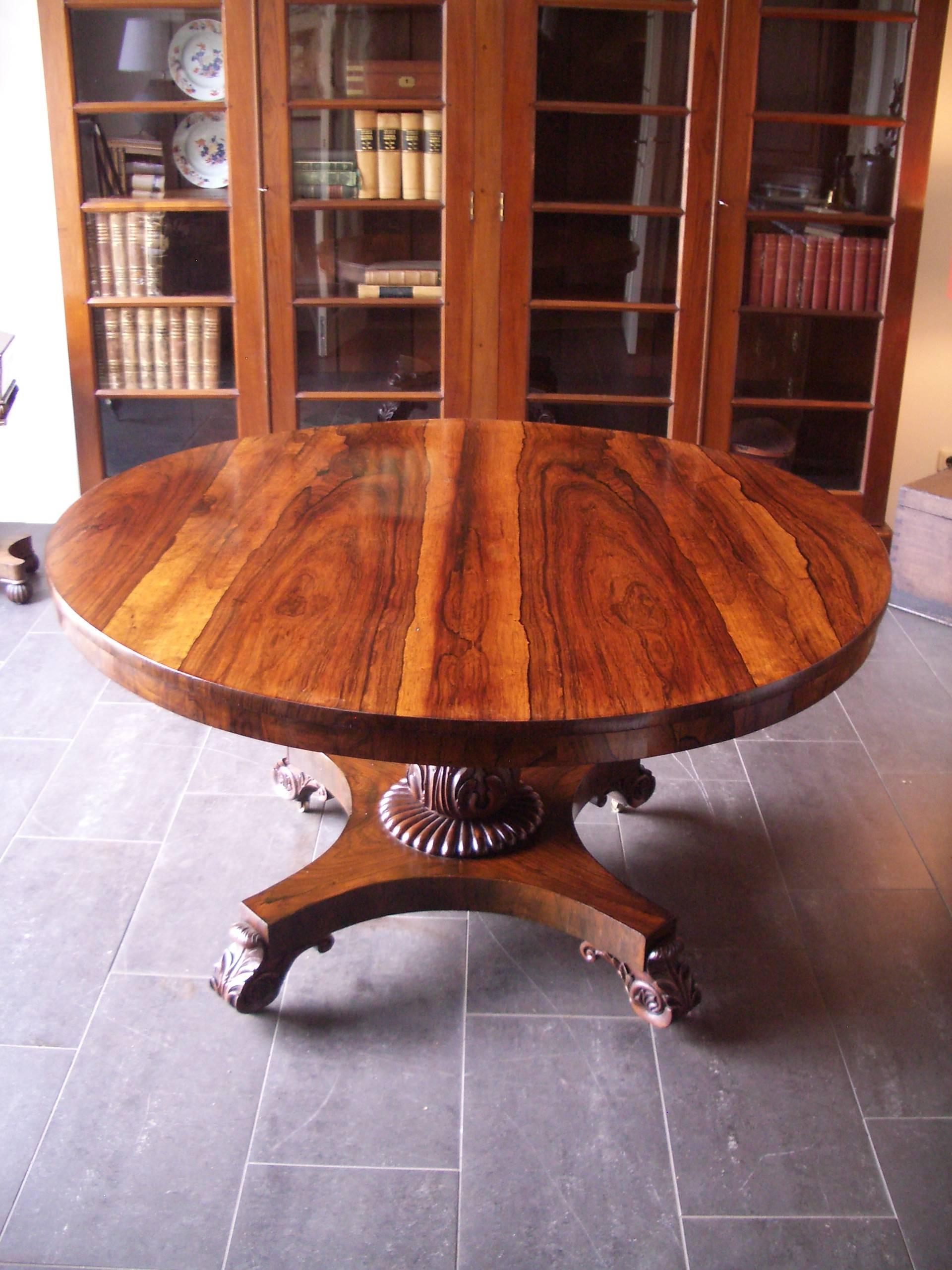 An English William IV Finely Figured Rosewood Regency Tilt-Top Pedestal Table, the circular tilt-top with a very finely figured rosewood top and a rosewood cross banded edge, the substantial tapering central support resting on a rosewood base raised