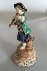 Meissen Figurine of Boy with Flute and Wine Barrel