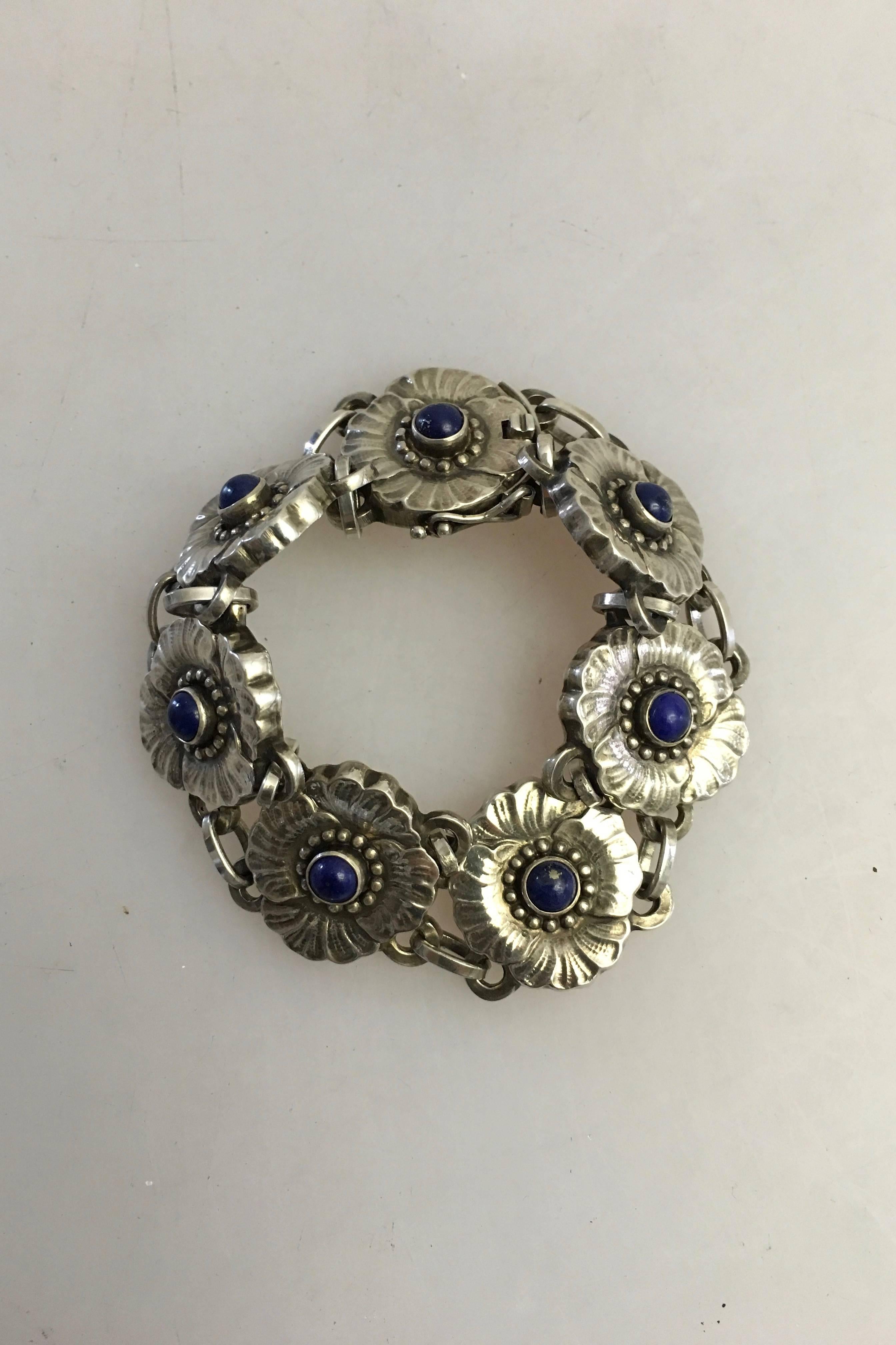 Georg Jensen sterling silver bracelet #36 with Lapis Lazuli. From after 1945. Consists of seven Links. 

Measures: 17 cm L (6 11/16