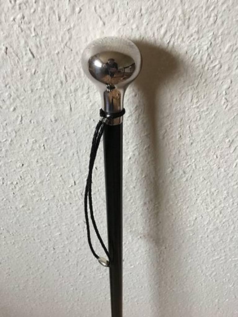 Georg Jensen walking stick in black lacquered wood with sterling silver knob and leather wristband. Measures: 110 cm L. Manufactured after 1945, and in great condition.