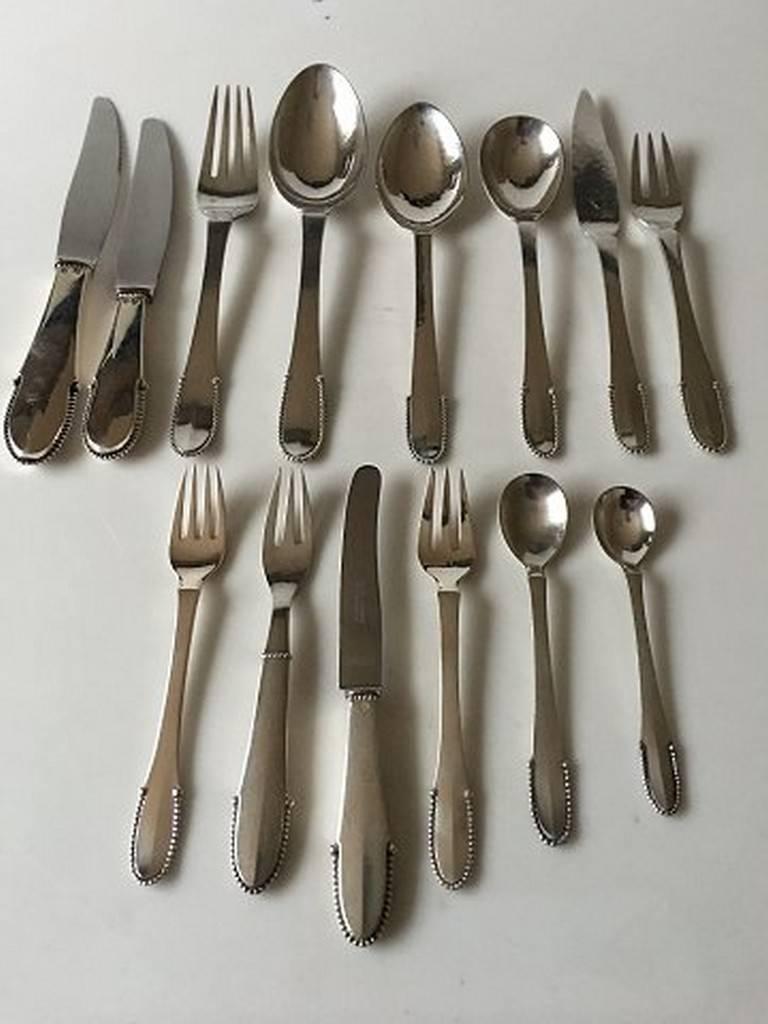Georg Jensen sterling silver beaded flatware set for four persons of 56 pieces. The set consists of: 

Four dinner knives with grill blade 21.3 cm (8 25/64