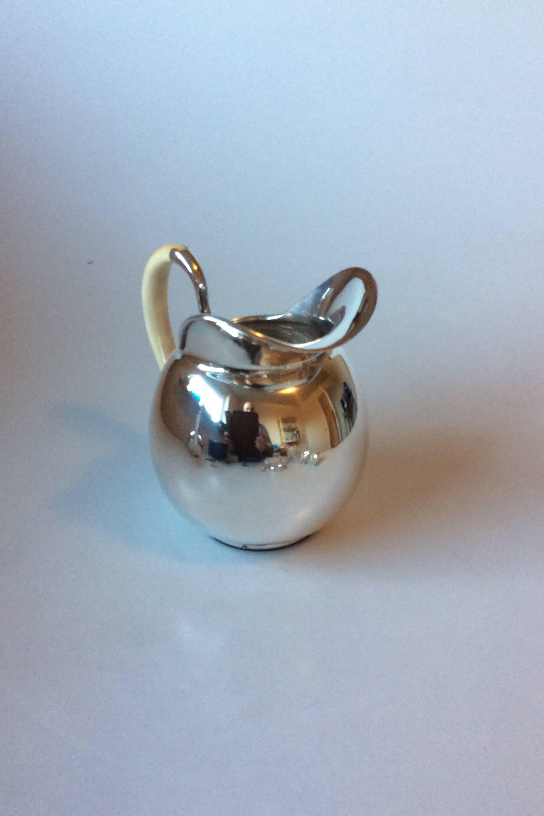 F. Hingelberg sterling silver water pitcher by Svend Weihrauch with bone handle.

Measures: 14cm / 5 1/2