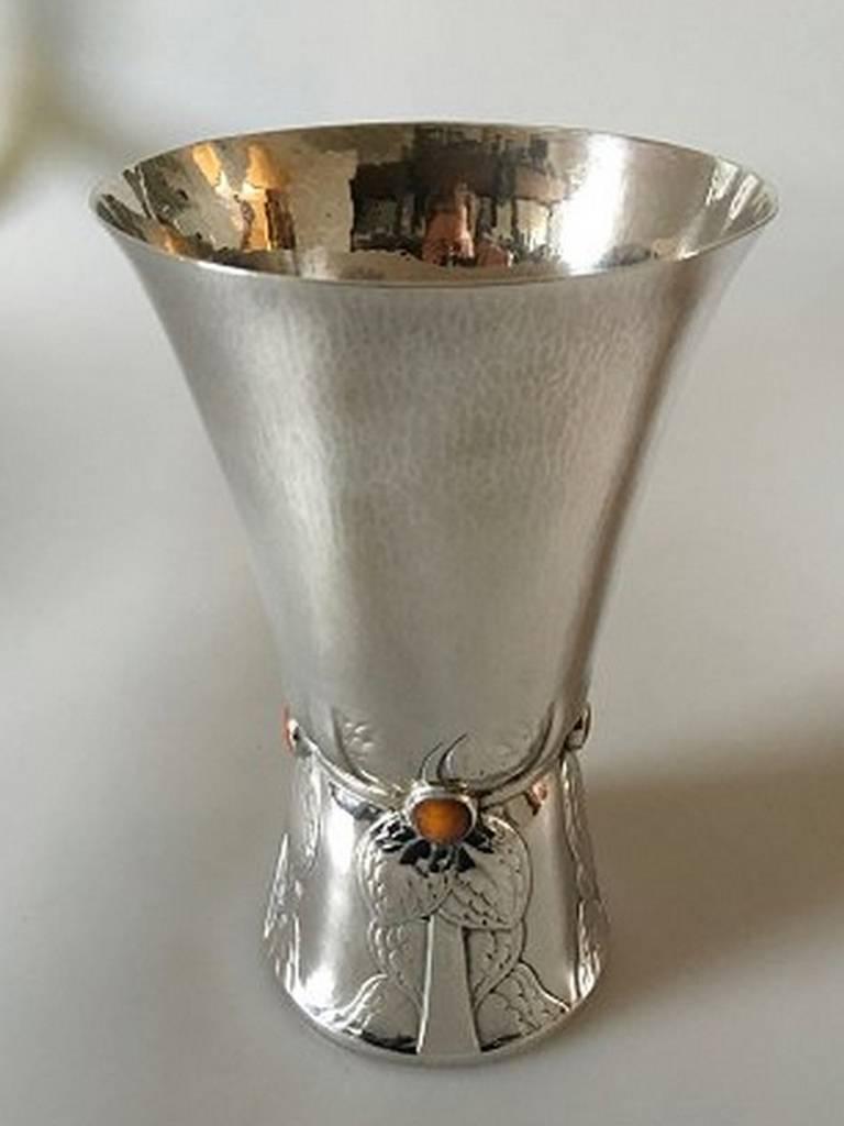 Georg Jensen silver vase with amber stones #116. The vase is ornamented with a leaf motif and four amber stones. From 1915-1920.

Measures: 20.6 cm H (8 7/64 in.). 12.7 cm dia (5 in). Weighs 430 g / 15.25 oz.