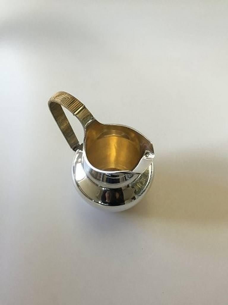 Georg Jensen sterling silver water pitcher designed by Ib Bluitgen #894A. Measures 21cm and is in good condition.