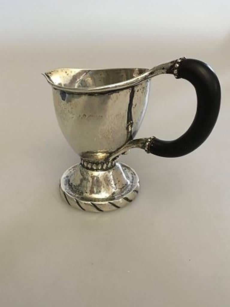 Georg Jensen early silver sauce creamer with wooden handle. From 1904-1908.

Measures: 12.5 cm H (4 59/64 in.) 7.5 cm dia (2 61/64 in). Weighs 156 g / 5.80 oz.
 