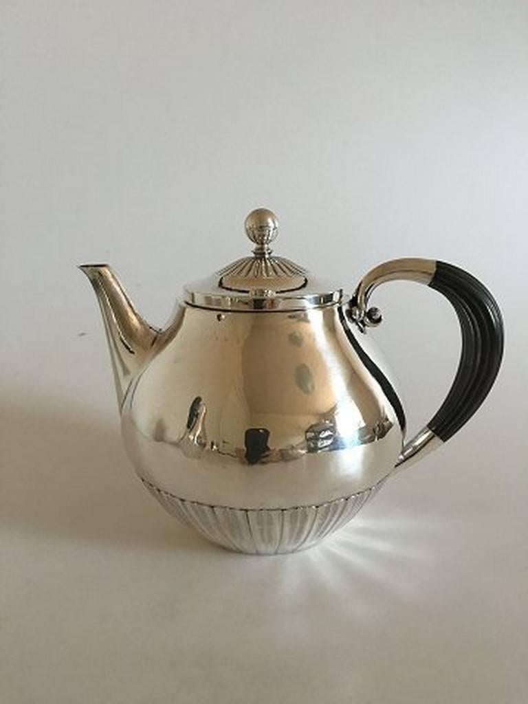 Georg Jensen sterling silver cosmos coffee and tea pot with creamer and sugar #45.

Measures: Teapot #45 6 1/2 in. (16.5cm) tall
Coffee pot #45 9 1/2 in. (24cm) tall
Creamer #45 4 3/8 in. (11cm) tall
Sugar #45 4 in. (10cm) tall.