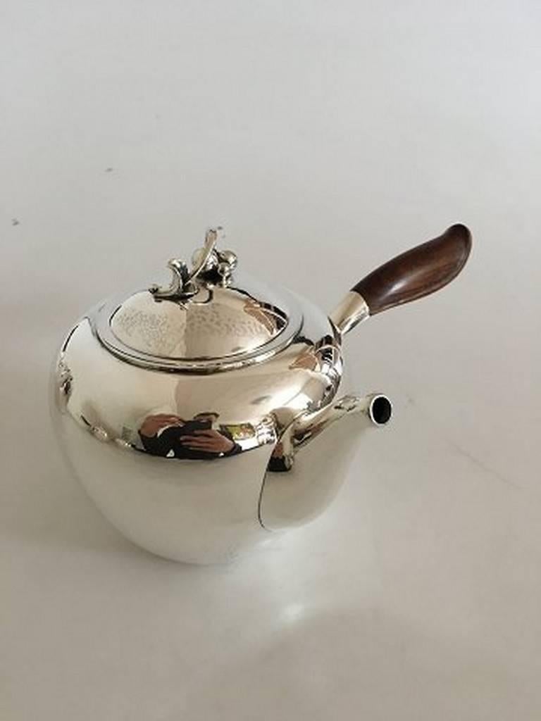 Georg Jensen sterling silver tea set no. 875. Teapot no. 875, water pitcher no. 875, creamer no. 875, sugar bowl no. 875A. Designed by Harald Nielsen. The set is from after 1945 and in great condition.

Measure: Teapot 11 cm H / 1 L, weight 486