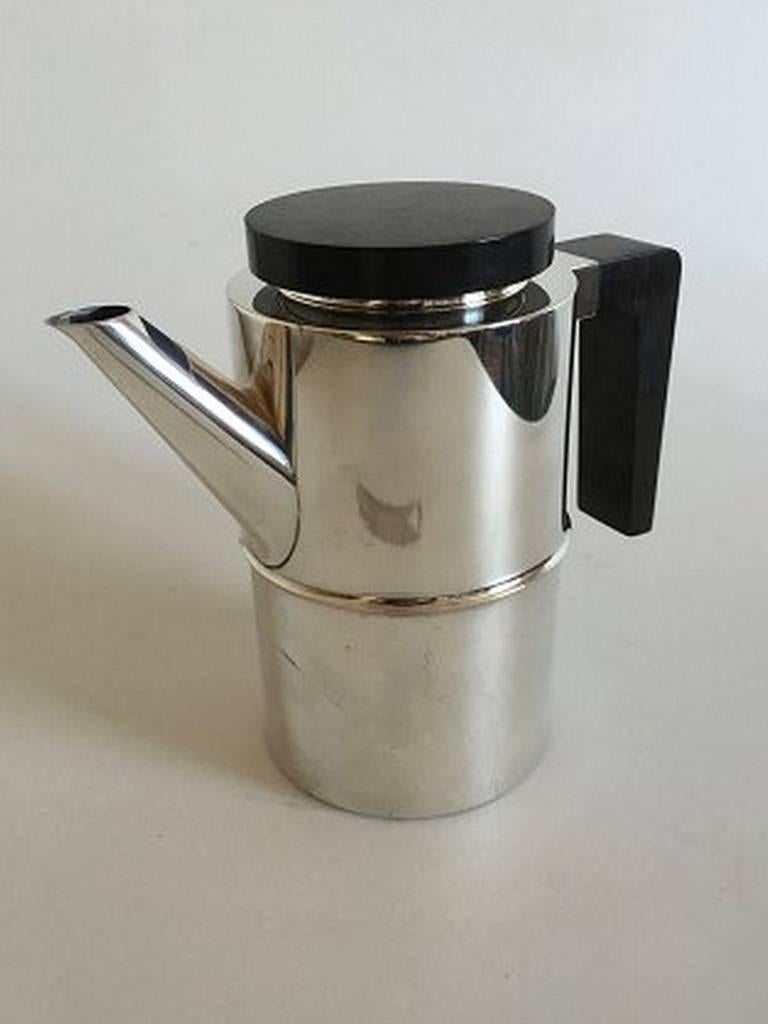 Georg Jensen sterling silver coffee pot with wooden handle and lid #1143 designed by Soren Georg Jensen. Weighs 816 g / 28.80 oz. 18 x 10 cm (7 3/32 in. x 3 15/16 in).
     