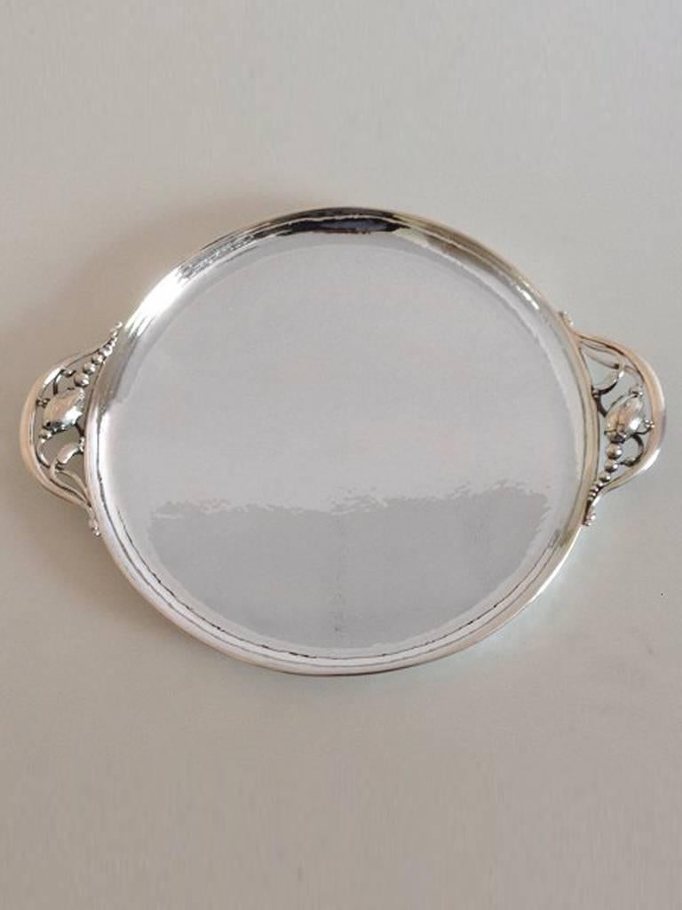 Georg Jensen sterling silver blossom round tray with handles #2AB.

With vintage marks from 1945-1951.

Measures 35cm / 13 3/4 in. with handles and 28cm / 11 in. without. Weighs aproximately 780 g.