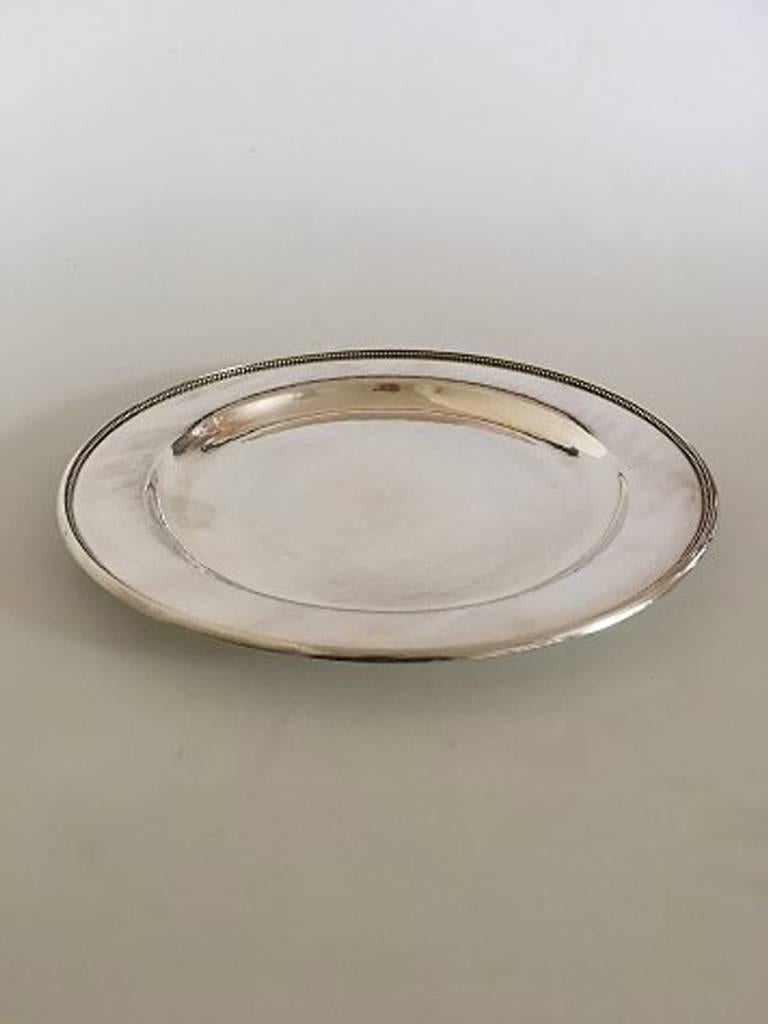 Georg Jensen sterling silver plate/tray No. 210 N. Measures 28 cm diameter (11 1/32 in.). Weighs 650 grams. Manufactured after 1945.