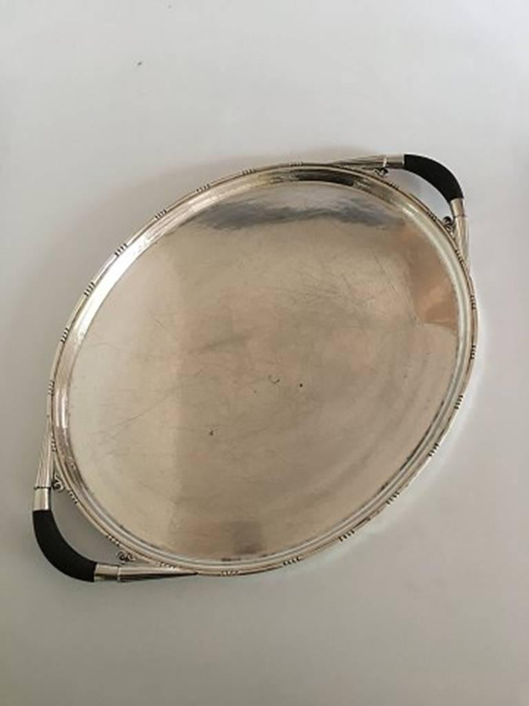 Georg Jensen oval sterling silver serving tray no. 251C with wooden handles. Measures 60 x 40 cm (23 5/8 in. x 15 3/4 in.). The platter is from circa 1925-1932. In nice condition.