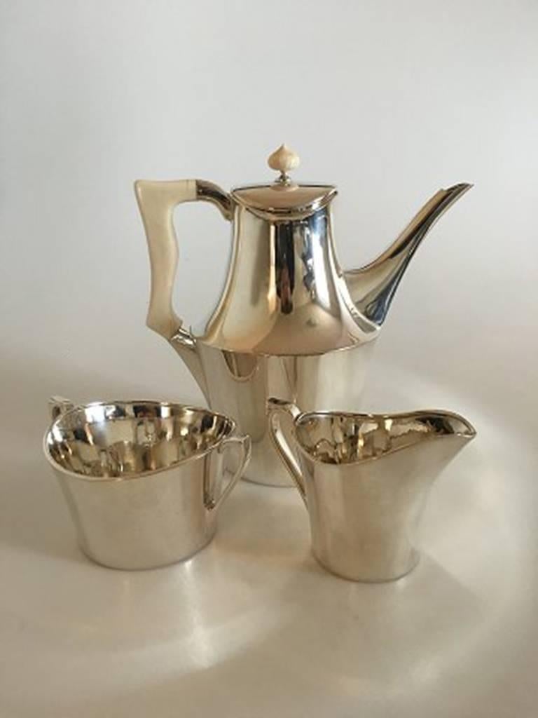 Hans Hansen sterling silver coffee set #457. With coffee pot, creamer and sugar bowl. Handle made of Bone in good condition. From 1957. Measure: Coffee pot 18 cm tall (7 3/32 in). Creamer 7.5 cm H (2 61/64 in). Sugar bowl 9.5 cm diameter (3 47/64