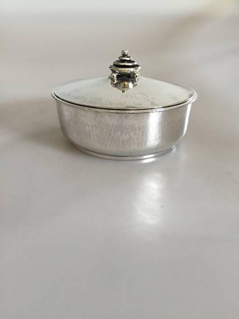 Hans Hansen lidded box in sterling silver by Karl Gustav Hansen from 1933. Measures 10.1cm in diameter.