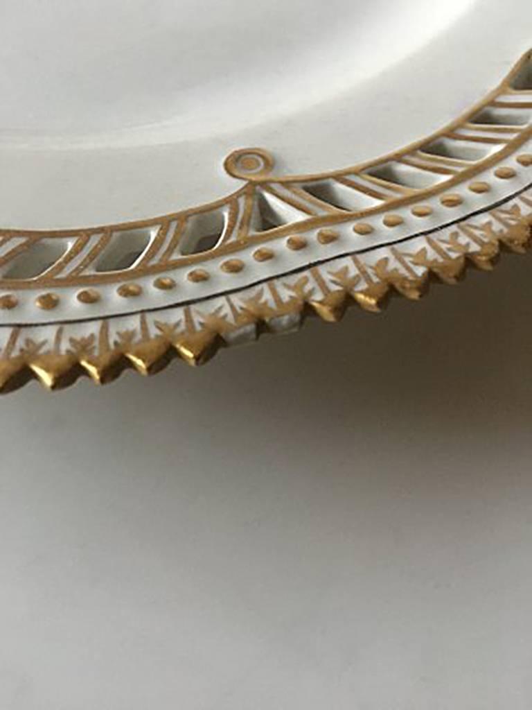 Royal Copenhagen Flora Danica plate with pierced border and monogram. 2nd quality and is chipped on the edge. Measurers 23 cm diameter (9 1/16 in).