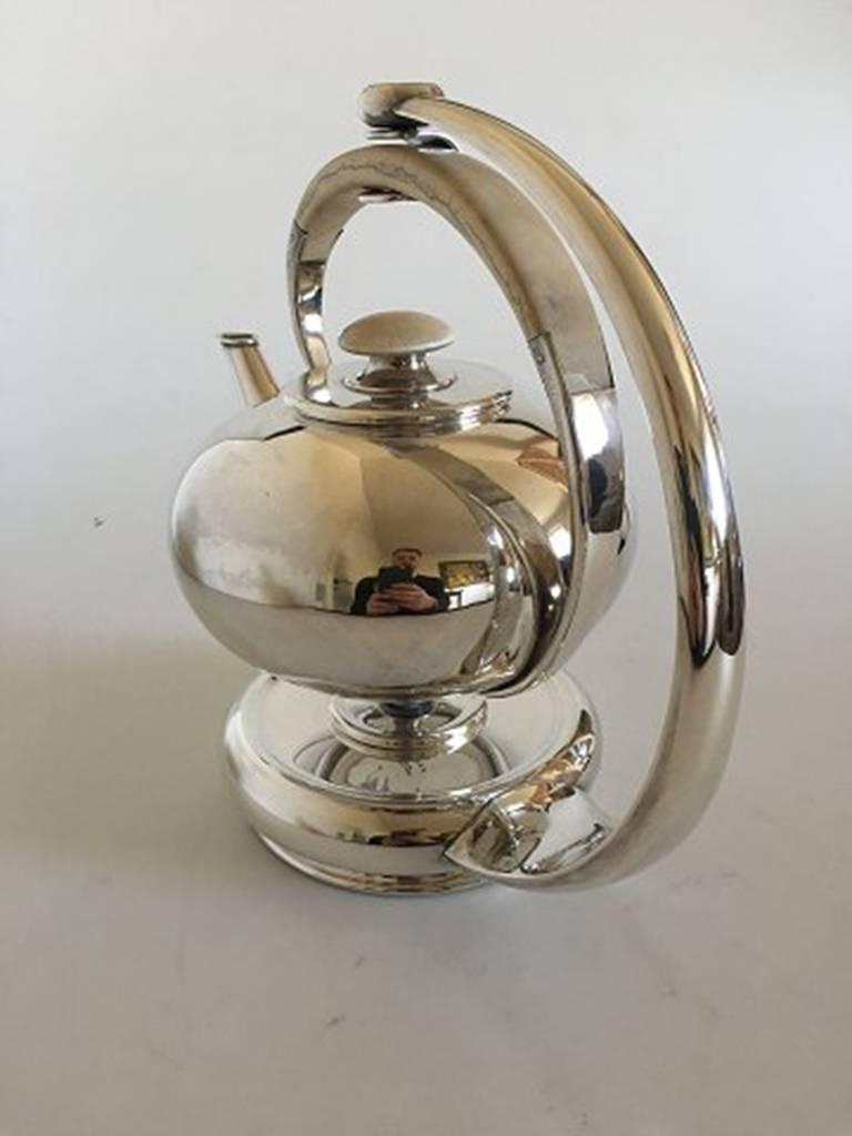 F. Hingelberg Sterling Silver Teapot with Bone Handle and Matching Heating Stand. The Tea Pot measures to the top of the handle 18 cm H (7 3/32 in;). The heating stand measures 25.5 cm H (10 3/64 in). In good condition, but the bone does have some