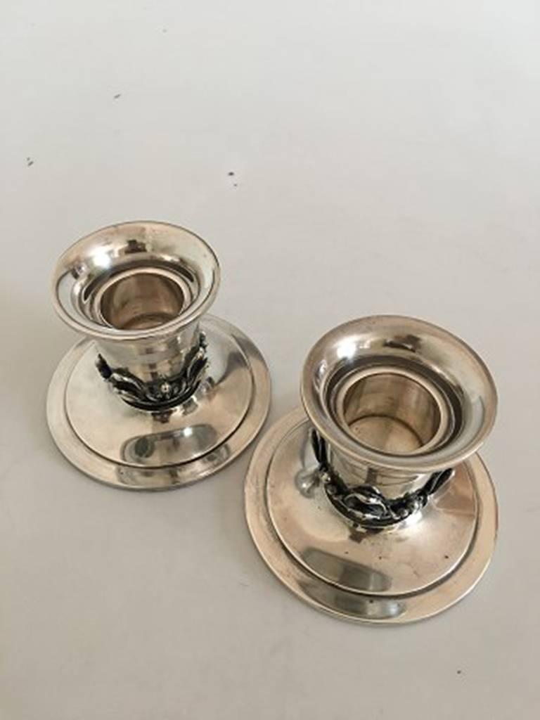 Gran & Laglye Silver Candle Holders. 11 cm H. Foot measures 14.5 cm dia. Fits a candle with diameter of about 4.5 cm. Each candle holder weighs 434 grams. In good condition.