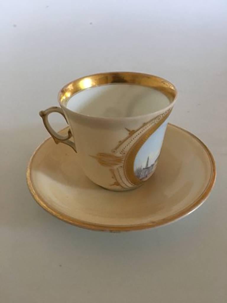 Bing & Grondahl early cup, motif, the exchange with saucer and royal monogram

In good conditon. With light gold wear.

Measures 6.7cm/ 2 2/3 in. high and 7.6cm / 3 in. diameter. Saucer measures 13.8cm / 5 2/5 in.