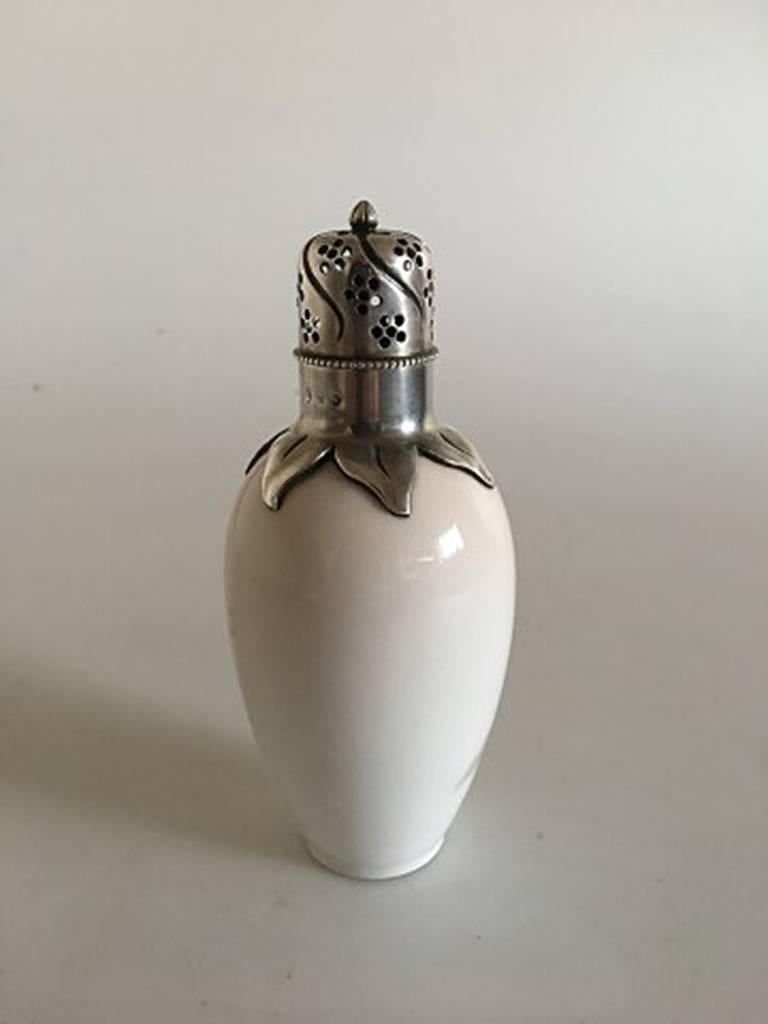 Royal Copenhagen Art Nouveau Anton Michelsen silver mounted sugar shaker #299/47A with butterfly motif.
Measures 15 cm / 6 inches.