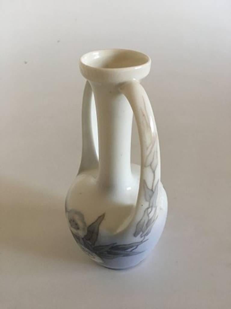 Royal Copenhagen Art Nouveau vase with two handles #951/60A. Measures 17 cm and is in good condition.