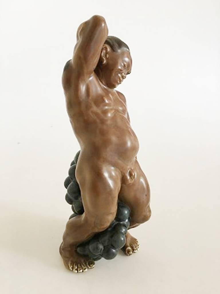 Kai Nielsen stoneware figurine no. 25 man with grapes. 23.5 cm h (9 1/4