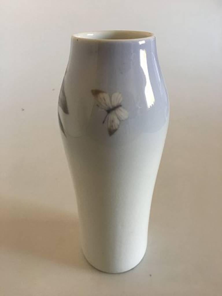 Royal Copenhagen vase #181/232 with wisteria flower motif. Measure: 23.5 cm H (9 1/4 inches). 2nd quality (The vase has some burning mistakes in the glaze around the flower motif, otherwise in good condition).