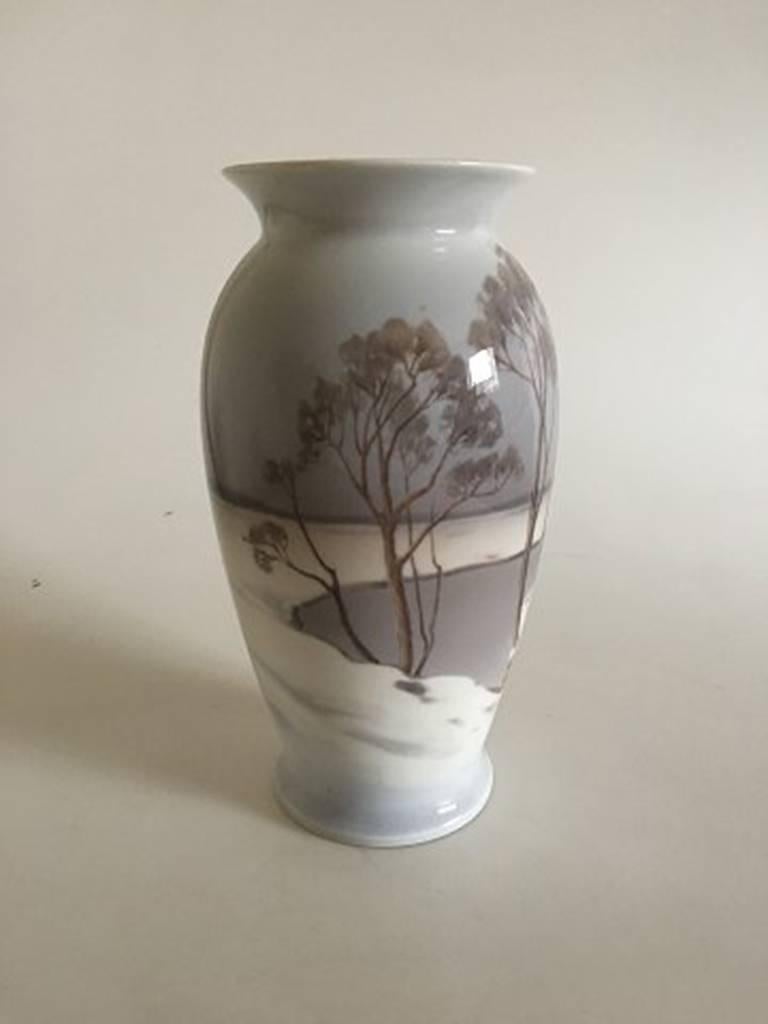 Bing & Grondahl Art Nouveau vase by Clara Nielsen with snow landscape #8591/370. Measures 25.2cm / 9 9/10 in. and is in good condition.