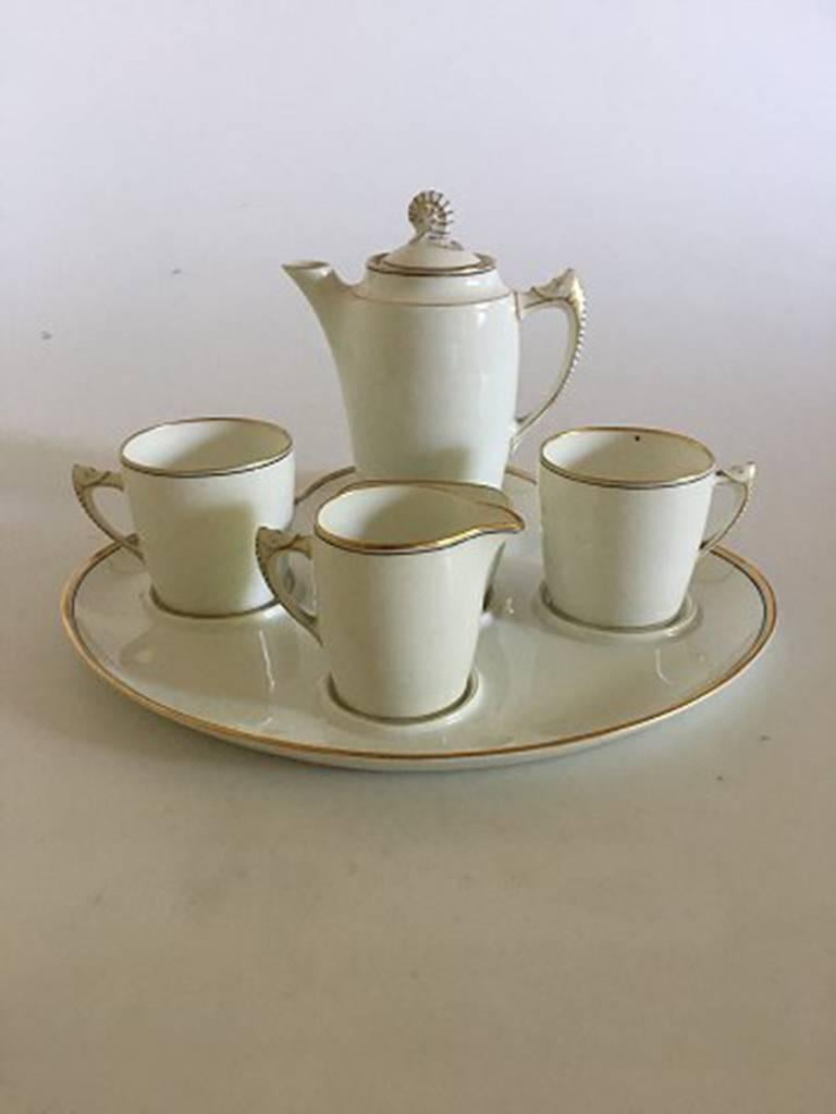 Bing & Grondahl mocha set, with tray, jug, creamer, two cups and sugar bowl.
In nice condition, with only minimal wear on the gold. The mocha jug measures 12 cm H. With old B&G Stamps.