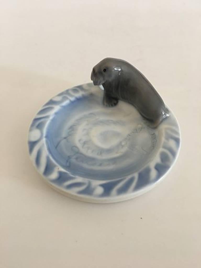 Bing & Grondahl Art Nouveau ashtray with walrus. Measures 12 cm. Difficult to read the inscription, but something with Rudolf Jensen 1899 24 April. The piece has a burn mistake.