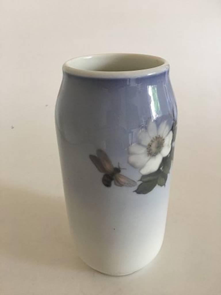 Royal Copenhagen vase #693/2304 with a motif of two white roses and a bee. Measures: 23 cm H (9 1/16 in). 1st quality, in nice whole condition.
