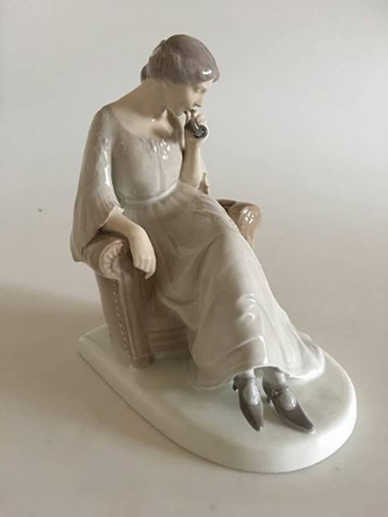Bing & Grondahl figurine of sitting woman with phone #1706.

Designed by Axel Locker

Measures 24cm.