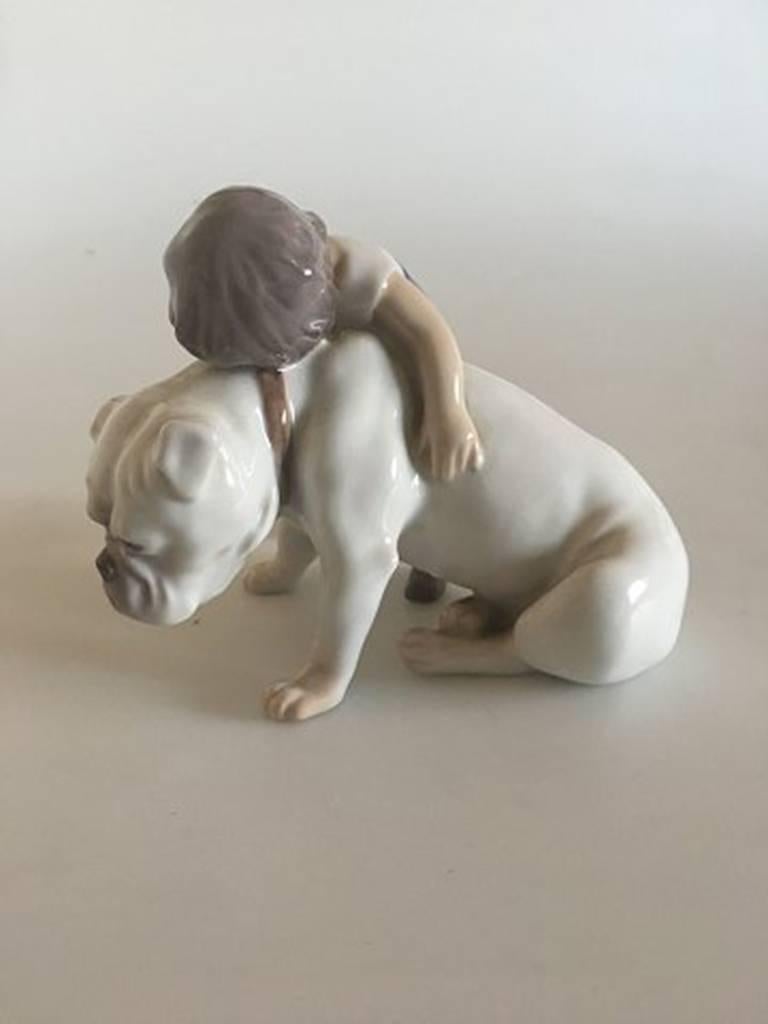 Bing & Grondahl figurine boy with bulldog #1790. Measures 12cm x 10cm and is in perfect condition.