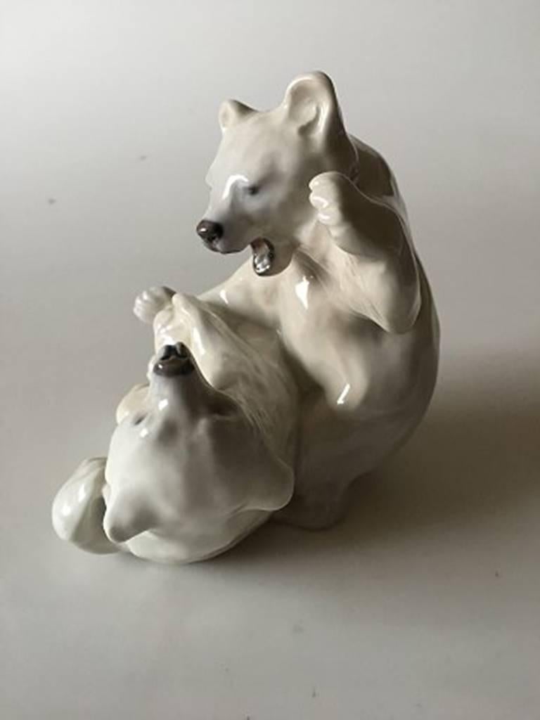 Royal Copenhagen figurine playing polar bear cubs No 1107. Measures 14 cm / 5 33864 in. Designed by Knud Kyhn. In perfect condition.