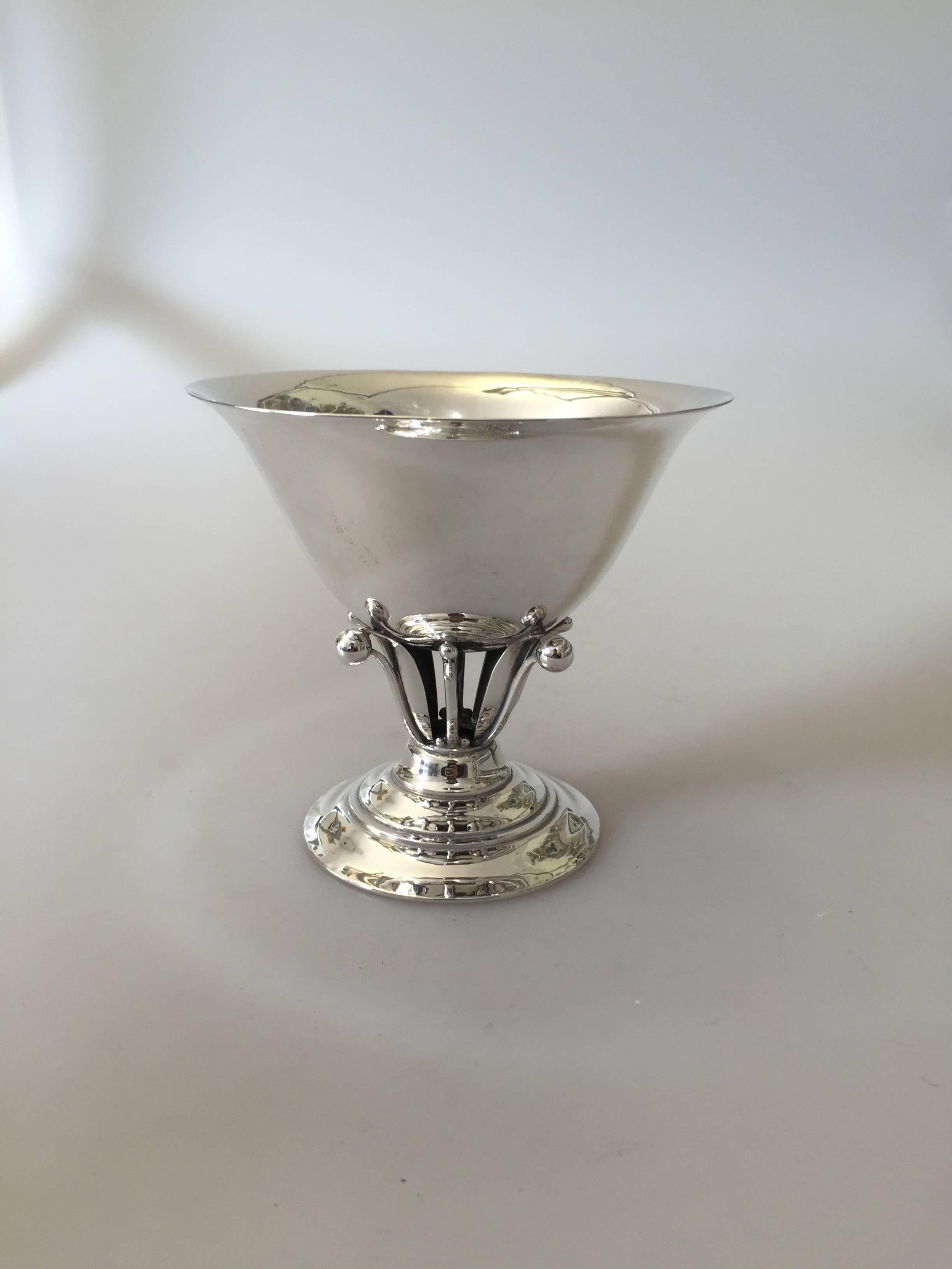 Georg Jensen footed bowl that is lifted on a floral pedestal, designed 1912 by Johan Rohde. 

Johan Rohde designed products for Georg Jensen Silver Smithy, beginning in 1906. Rohde's designs have much in common with Georg Jensen's own as in they