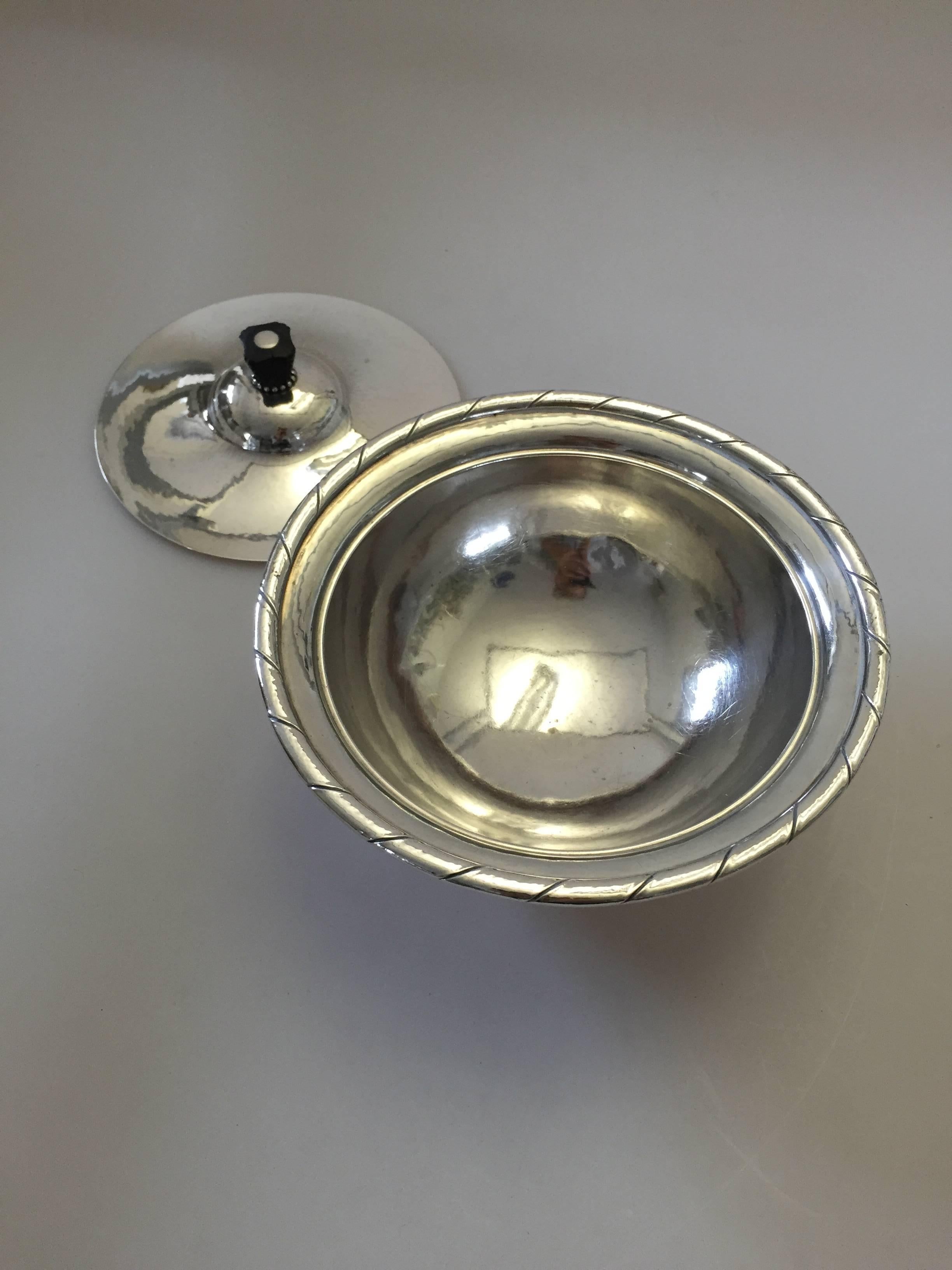 Georg Jensen sterling silver bowl with lid #88B. With marks post 1945. 

Georg Jensen (1866-1935) opened his small silver atelier in Copenhagen, Denmark in 1904. By 1935 the year of his death, he had received world acclaim and was hailed in the