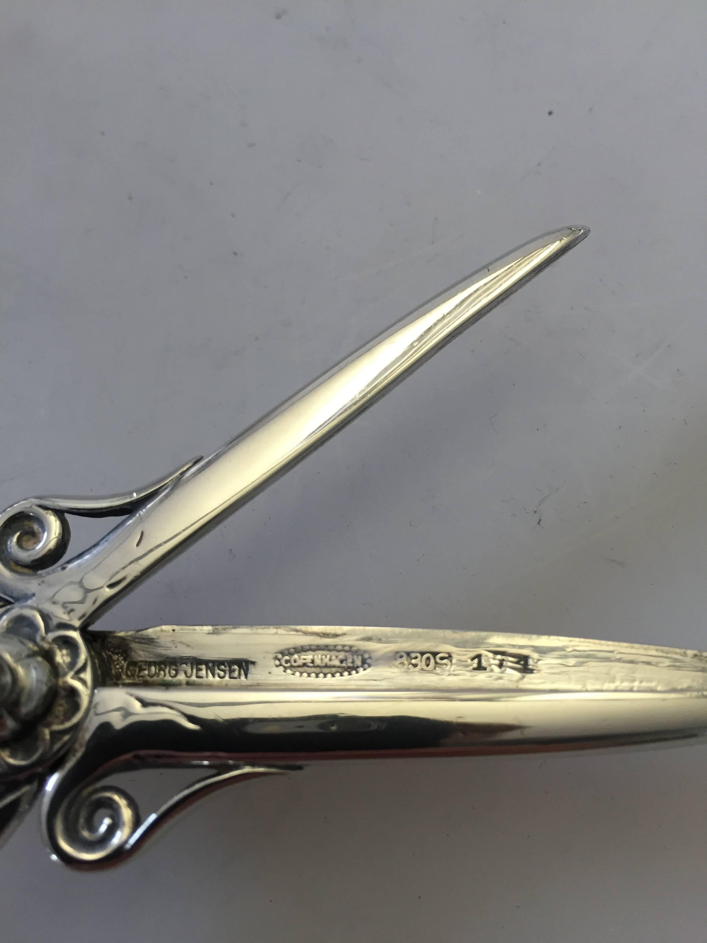 Georg Jensen sterling silver grape scissor with early marks. Weighs 61 g / 2.15 oz.

Georg Jensen (1866-1935) opened his small silver atelier in Copenhagen, Denmark in 1904. By 1935 the year of his death, he had received world acclaim and was