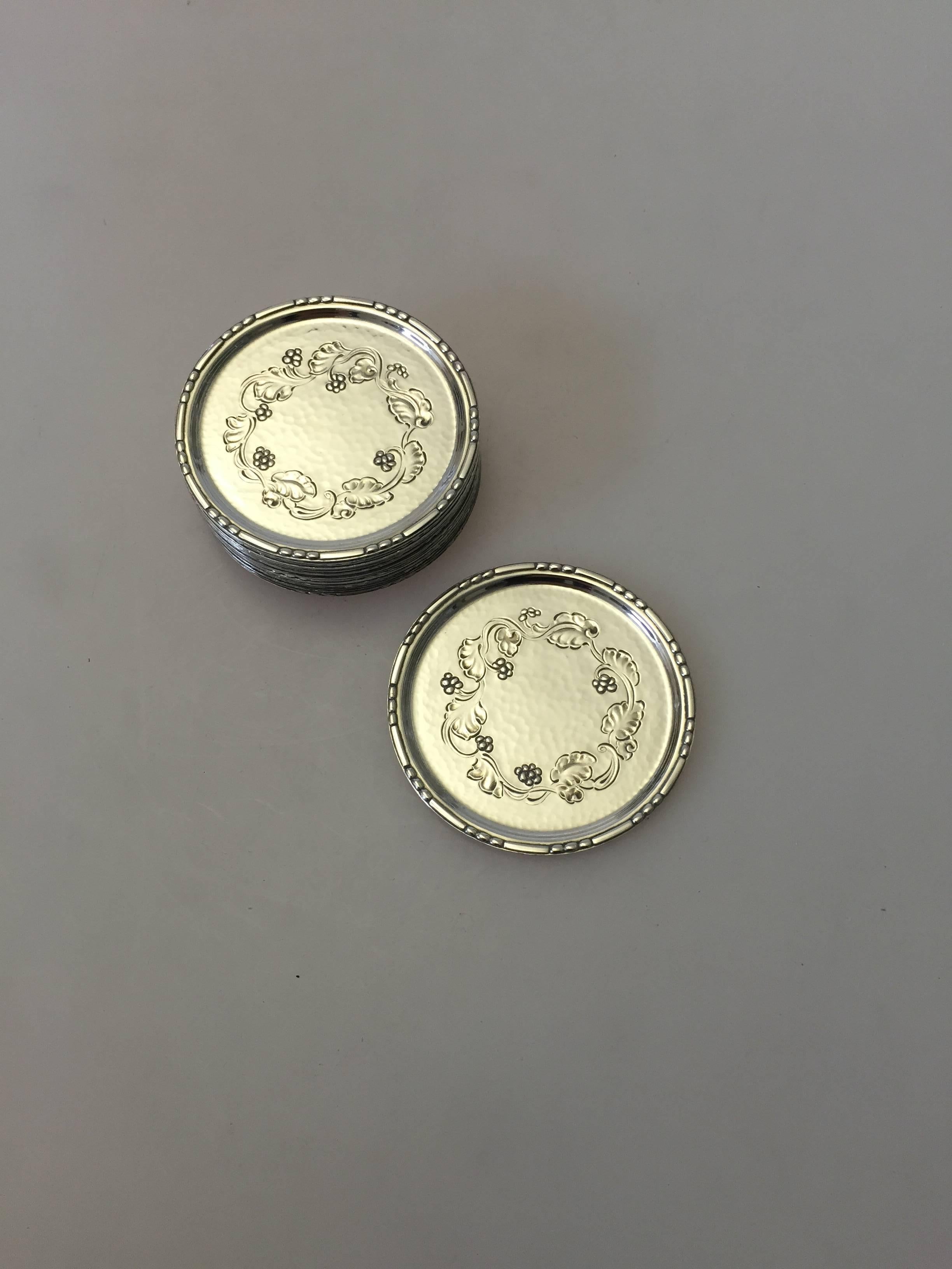 Georg Jensen sterling silver Harald Nielsen glass coasters with floral pattern. Diameter measures 6 cm and is in good condition. We currently have seven in loose stock and another 12, that we sell as a set.

Harald Nielsen (1892-1977) was the