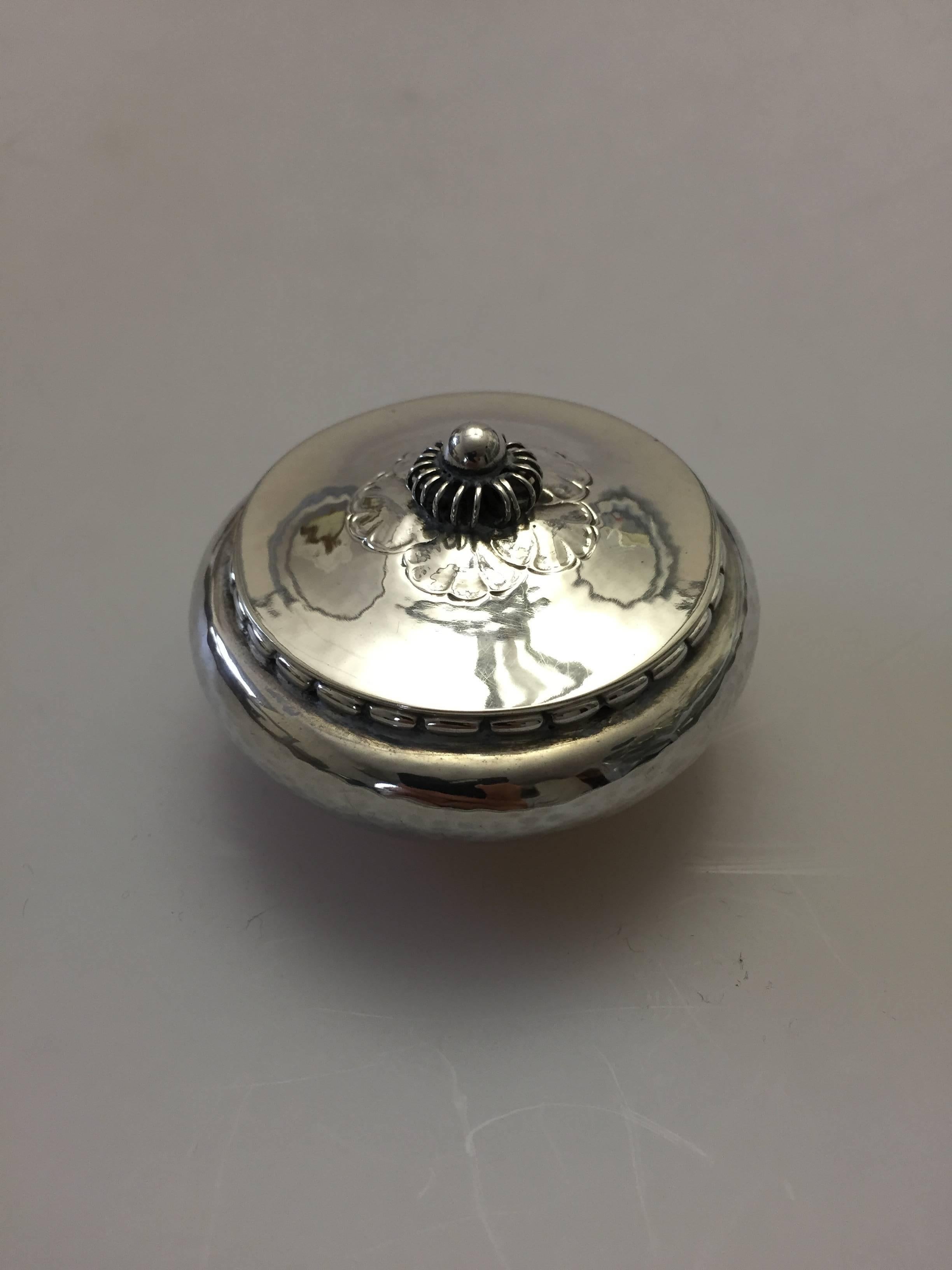 Georg Jensen sterling silver pill box with round curved bottom. Is in perfect condition.

Georg Jensen (1866-1935) opened his small silver atelier in Copenhagen, Denmark in 1904. By 1935 the year of his death, he had received world acclaim and was