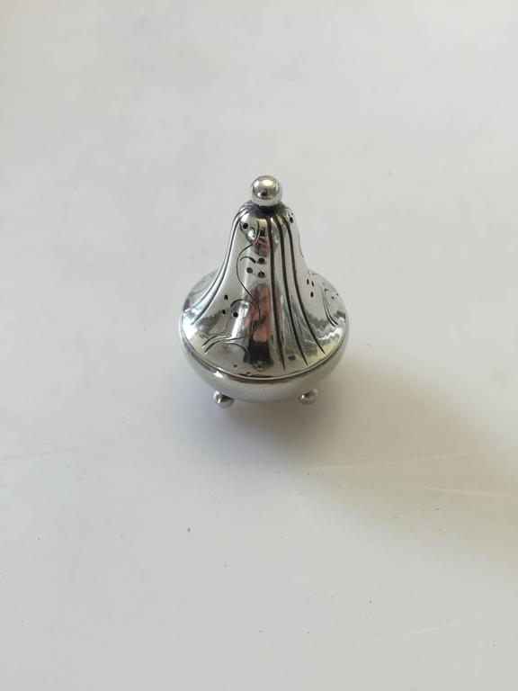 Georg Jensen sterling silver pepper shaker with floral decoration #433. The shaker measures 5 cm high. We have a total of five in stock all in perfect condition.

Georg Jensen (1866-1935) opened his small silver atelier in Copenhagen, Denmark in
