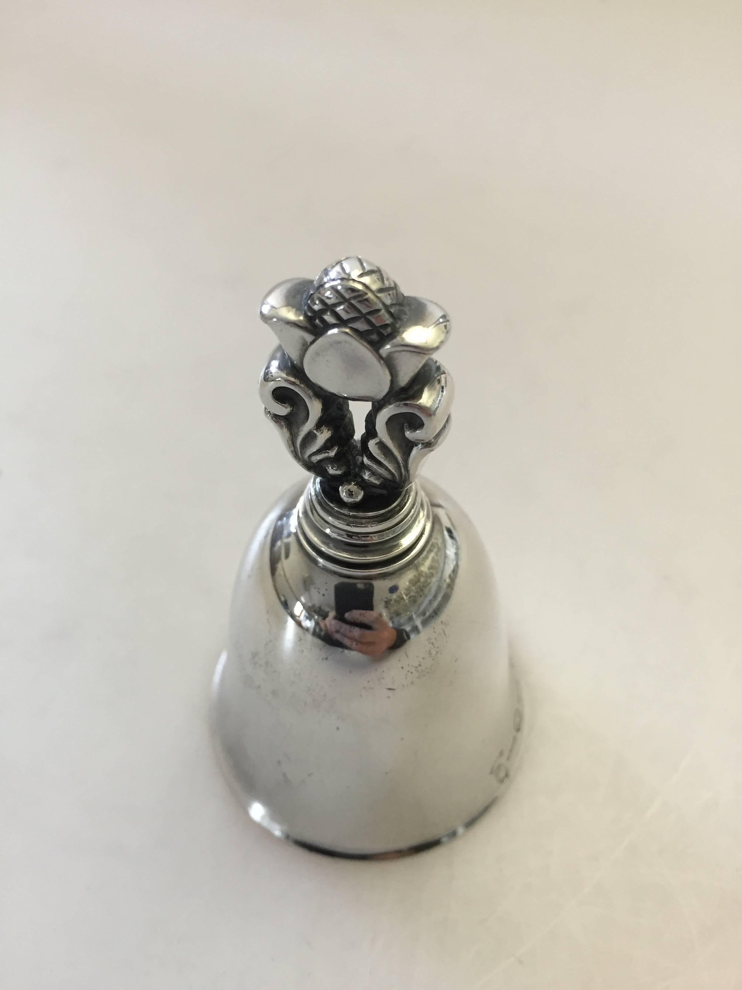 Georg Jensen sterling silver acorn table bell. The bell has old marks. It measures 8.5 cm high and is in a good condition.

Georg Jensen (1866-1935) opened his small silver atelier in Copenhagen, Denmark in 1904. By 1935 the year of his death, he